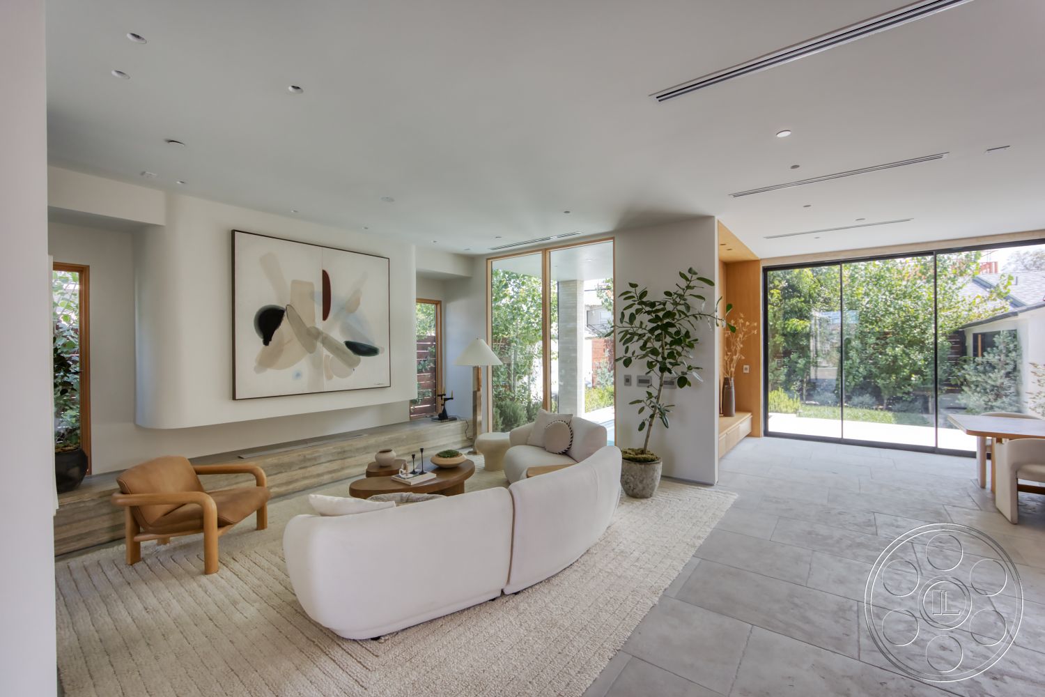 Modern 526 - neutral color palette, contemporary design, natural lighting, textured area rug, wooden coffee table, open floor plan, concrete flooring, large glass windows, green indoor plants, artwork on the wall, curved sofa, white painted walls, modern living room, minimalist armchair, wood framed windows