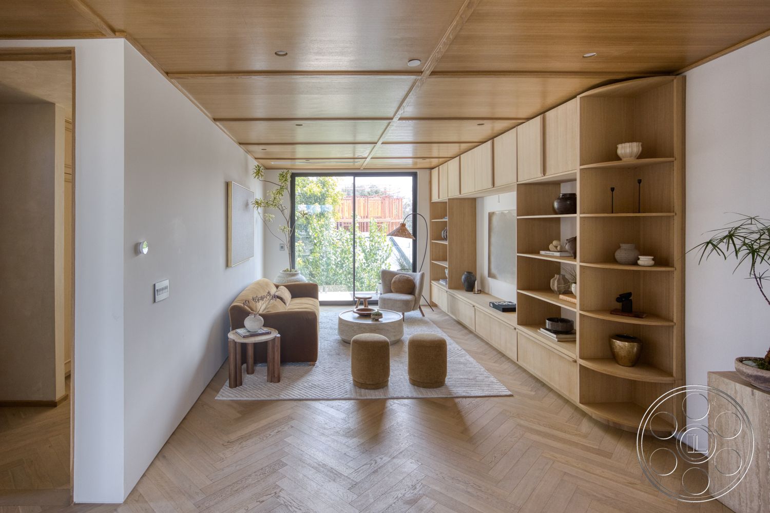 Modern 526 - neutral color palette, indoor plants, light wood furniture, textured area rug, cozy seating area, artwork on walls, floor-to-ceiling windows, contemporary coffee table, modern minimalist design, white painted walls, natural wood ceiling panels, herringbone hardwood flooring, built-in wooden shelving unit, open living room layout, round upholstered ottomans