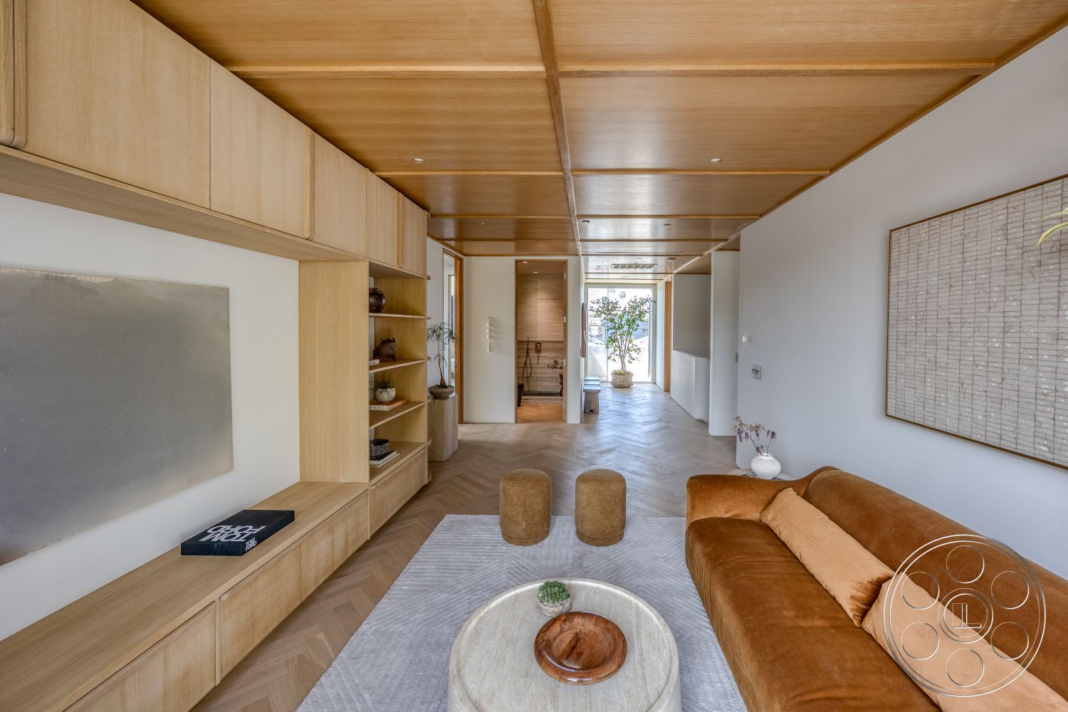 Modern 526 - contemporary style, round coffee table, light wood cabinetry, open living space, textured wall treatment, herringbone wood flooring, decorative shelves, pantry door, wood beam ceiling, geometric art piece, orange velvet sofa