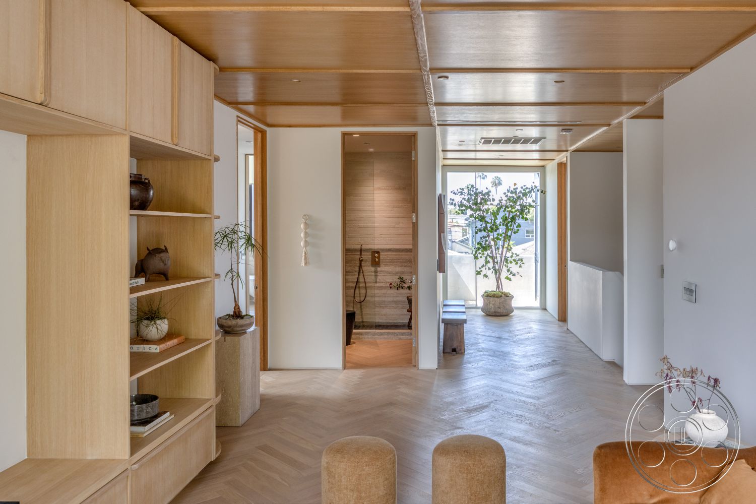 Modern 526 - neutral color palette, cozy seating area, light wood cabinetry, plaster walls, home office area, built-in shelving unit, natural light-filled room, exposed wood ceiling panels, herringbone hardwood flooring, glass door entry, ceramic plant pots, textured shower wall, bronze accent decor, minimalist open space