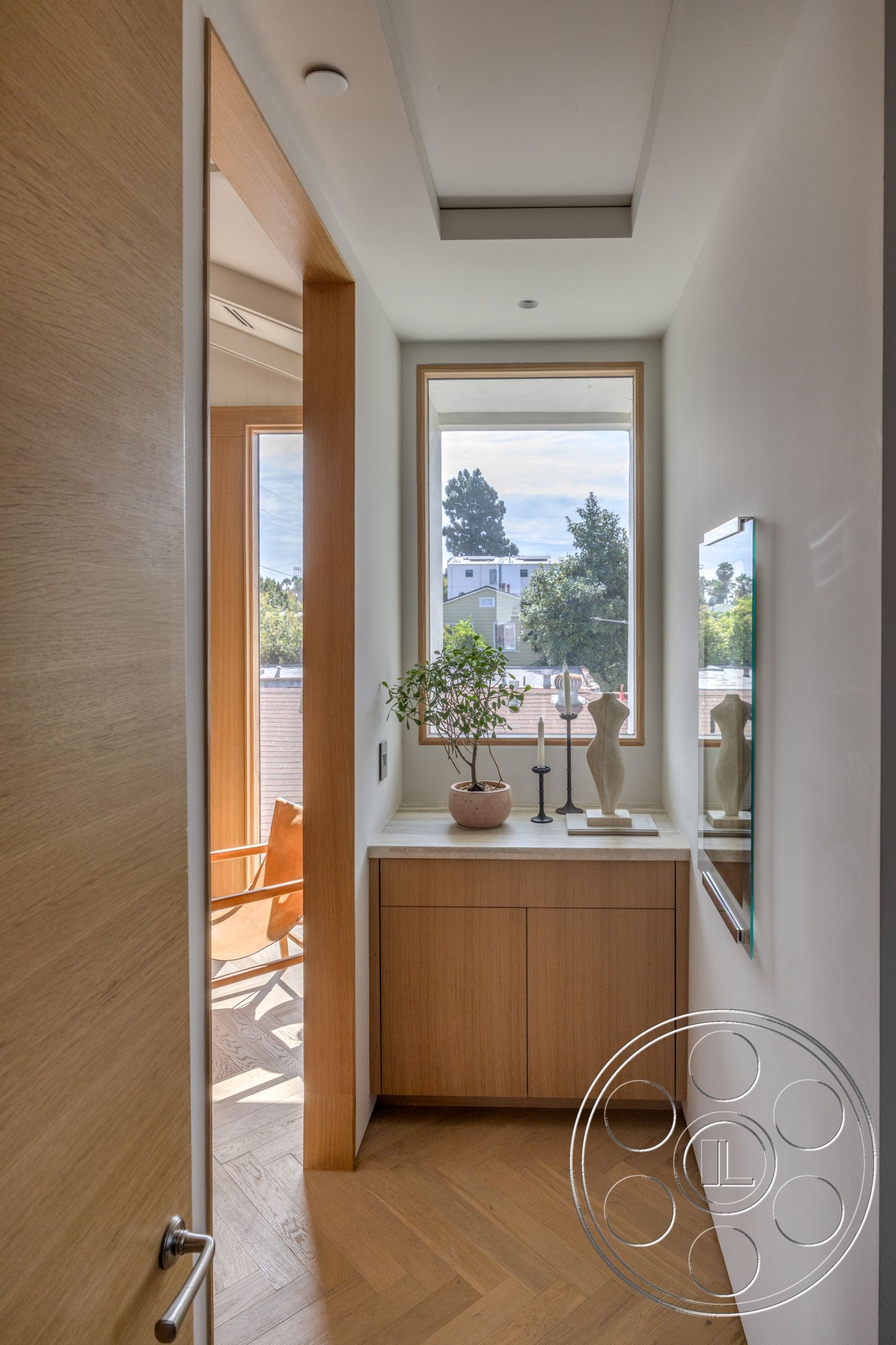 Modern 526 - natural light, contemporary design, minimalist aesthetic, sconce lighting, floor-to-ceiling window, wooden door frame, white painted walls, modern accent decor, herringbone hardwood flooring, natural wood cabinet, sculptural decor piece, built-in planter with greenery, bright entrance hall
