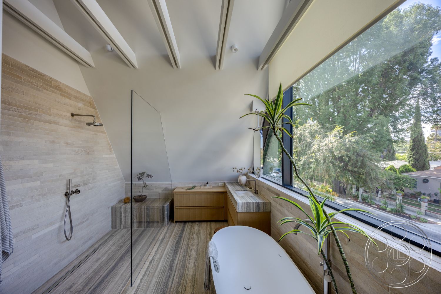 Modern 526 - natural light, modern bathroom, glass shower enclosure, floor-to-ceiling windows, freestanding oval bathtub, wood beam ceiling, textured plaster bathroom walls, stone bathroom flooring, built-in wood vanity