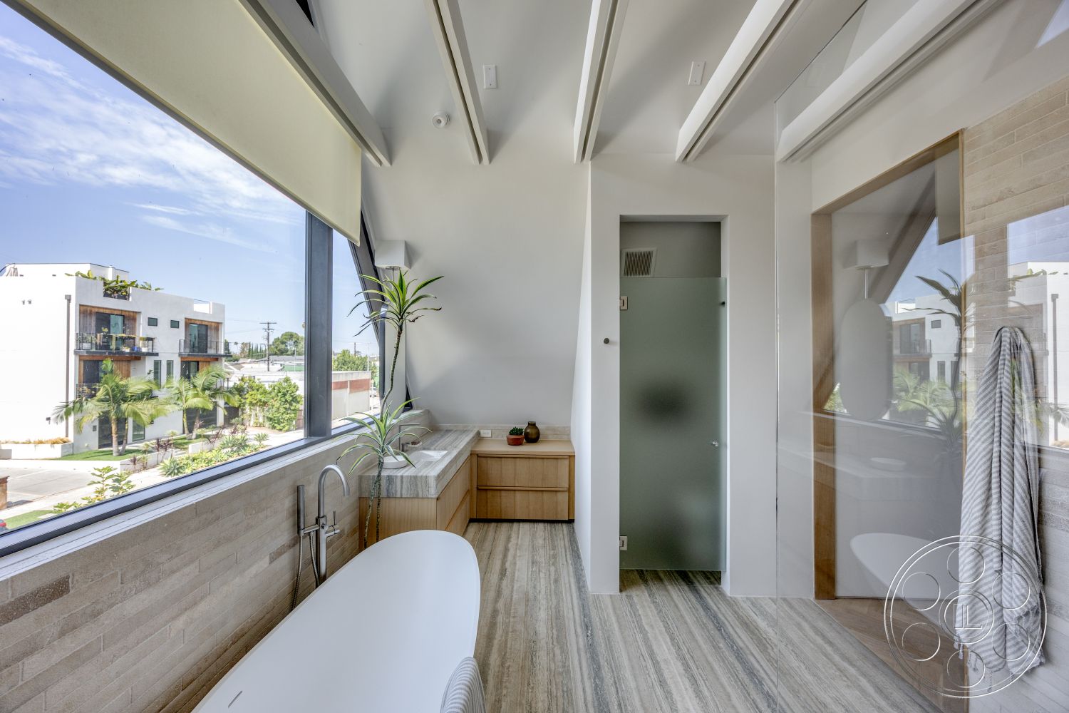 Modern 526 - minimalist decor, freestanding bathtub, glass shower enclosure, exposed beam ceiling, large floor-to-ceiling windows, modern bathroom design, wood paneling accent wall, textured stone bathroom walls, floating vanity with countertop, striped tile flooring, urban view from window