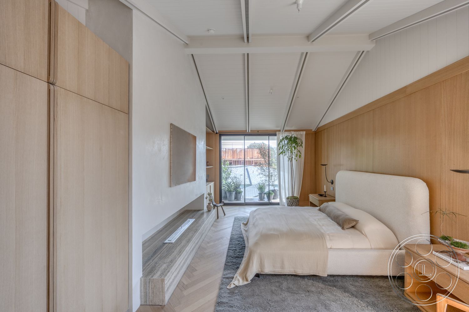 Modern 526 - sliding glass doors, light wood paneling, modern decorative planters, vaulted ceiling with exposed beams, chevron hardwood flooring, built-in wooden cabinetry, textured white plaster walls, neutral bedding, minimalist bed frame, soft upholstered headboard