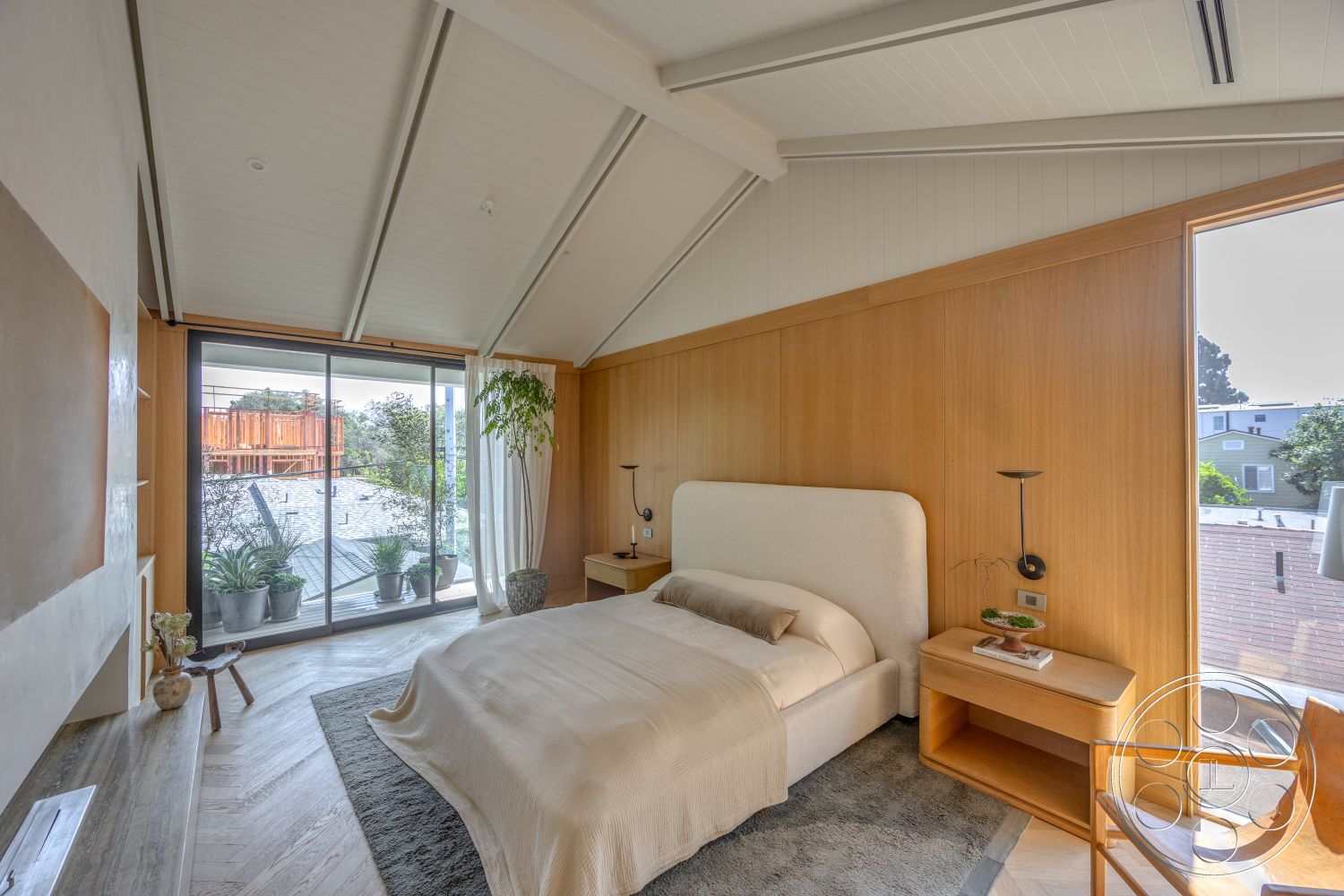Modern 526 - neutral color palette, indoor plants, large glass sliding doors, white curtains, contemporary chair, minimalist bedside table, vaulted ceiling with exposed beams, wood paneling walls, scenic balcony view, textured plaster wall accents, soft beige bedding, hardwood flooring in herringbone pattern, plush bed with upholstered headboard, modern reading lights