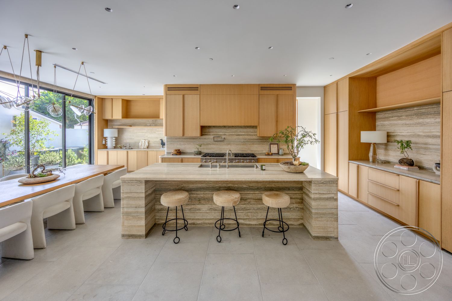 Modern 526 - neutral color palette, natural light, wood cabinetry, open concept layout, floor-to-ceiling windows, sliding glass door, textured wall treatment, modern bar stools, stone kitchen countertops, built-in kitchen appliances, concrete floor tiles, minimalist dining table, pendant light fixtures, natural stone backsplash