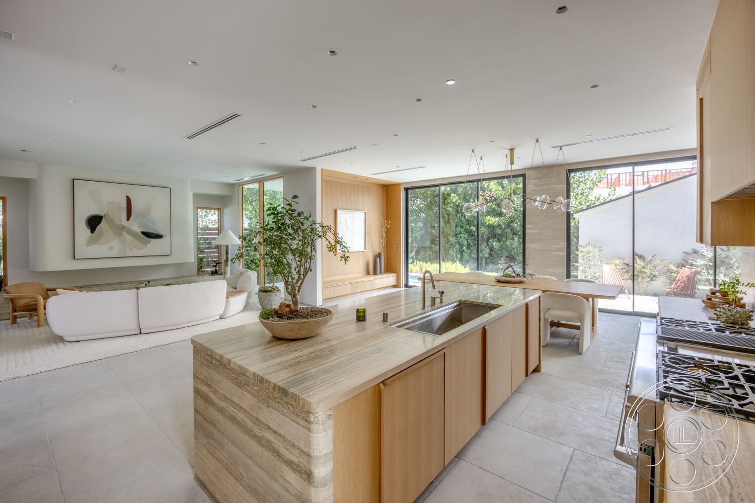 Modern 526 - modern kitchen, wood cabinetry, polished concrete flooring, glass sliding doors, artwork on wall, soft area rug, decorative indoor plant, contemporary light fixtures, open-concept living area, natural light from floor-to-ceiling windows, light-colored drywall walls, minimalistic furniture design, stone kitchen island