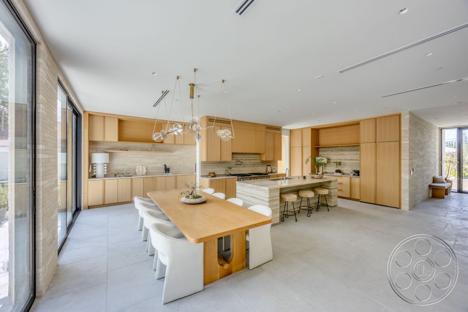 Modern 526 - minimalist aesthetic, warm wood tones, concrete floors, floor-to-ceiling windows, open-concept layout, modern dining table, oak cabinetry, pendant lighting fixtures, natural light-filled space, marble kitchen island, stone kitchen backsplash