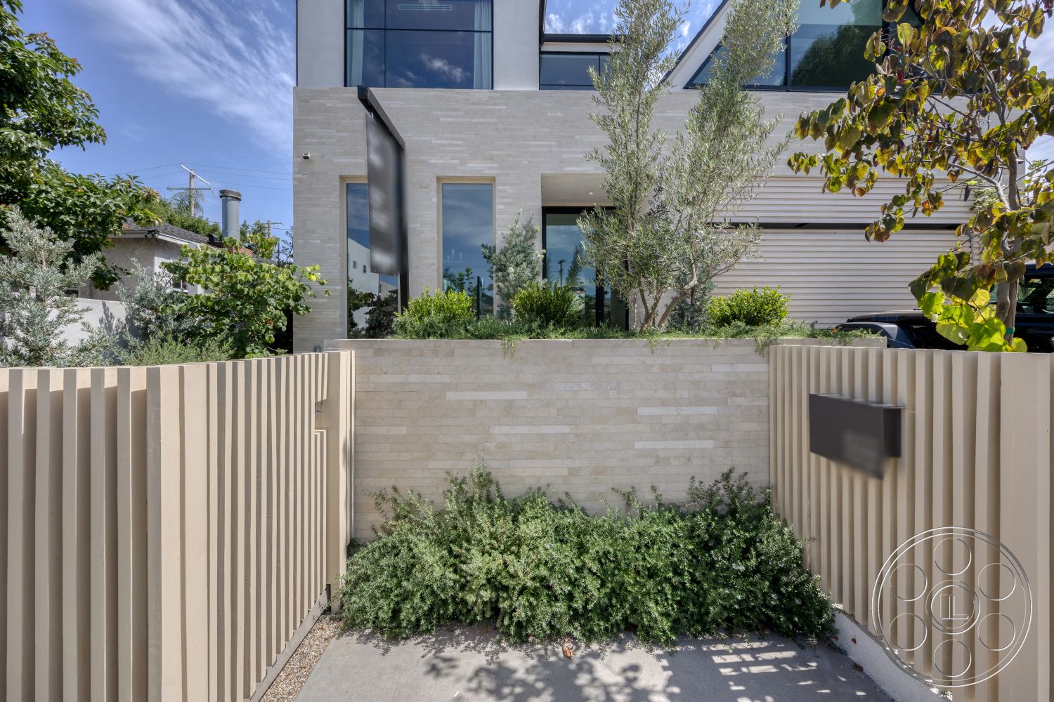 Modern 526 - exterior, landscaped garden, stone wall, concrete driveway, tall windows, contemporary architectural style, greenery surrounding, modern home entrance, horizontal wood slat fence, plaster facade