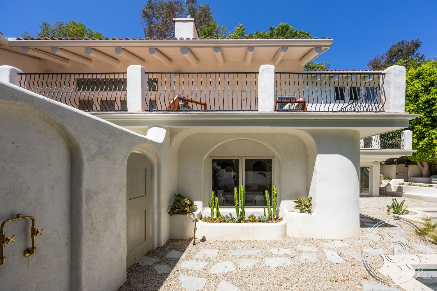 Medit 168 - outdoor seating area, floor-to-ceiling windows, desert landscaping, tile roof, metal balcony railings, concrete patio flooring, stucco exterior walls, curved architectural forms, built-in plant beds, interior courtyard setting