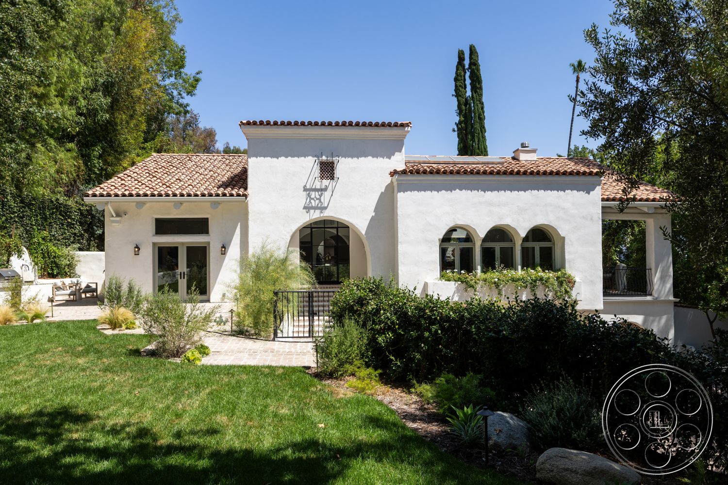 Medit 168 - exterior, landscaped garden, outdoor seating area, exposed wooden beams, grass lawn, red tile roof, stucco walls, arched windows, Mediterranean architectural style, paved patio flooring