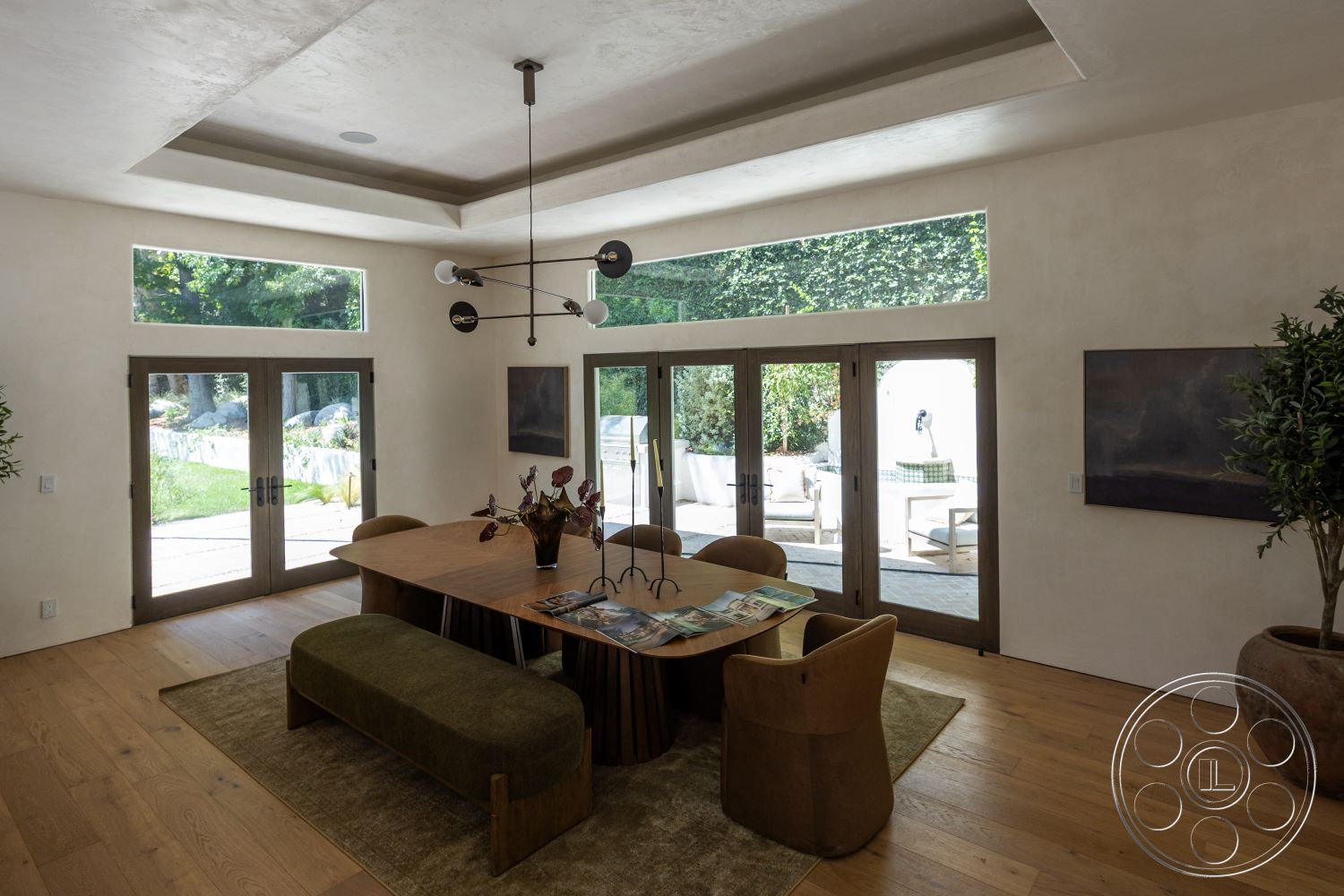 Medit 168 - neutral color palette, coffered ceiling, indoor plants, light wood flooring, wooden dining table, modern pendant light fixture, interior dining room, floor-to-ceiling glass doors, upholstered circular dining chairs, exposed plaster wall finish, landscaped exterior view