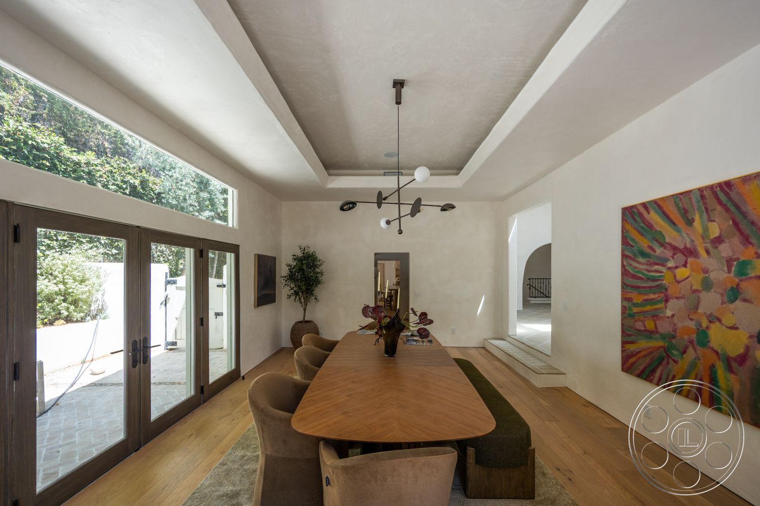 Medit 168 - large windows, hardwood flooring, large glass sliding doors, open floor plan, upholstered dining chairs, floor-to-ceiling windows, natural wood dining table, decorative indoor plant, textured plaster walls, soft color palette, high ceiling with recessed lighting, geometric art piece, linear pendant light fixture