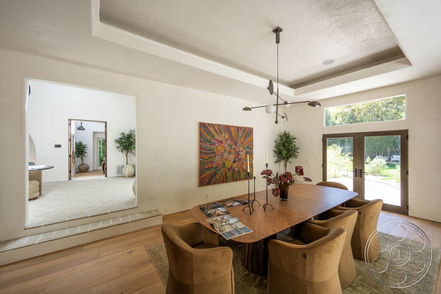 Medit 168 - large windows, natural light, hardwood flooring, coffered ceiling, contemporary design, indoor plants, open floor plan, upholstered dining chairs, colorful wall art, wood dining table, textured plaster walls, elegant dining area, modern light fixture