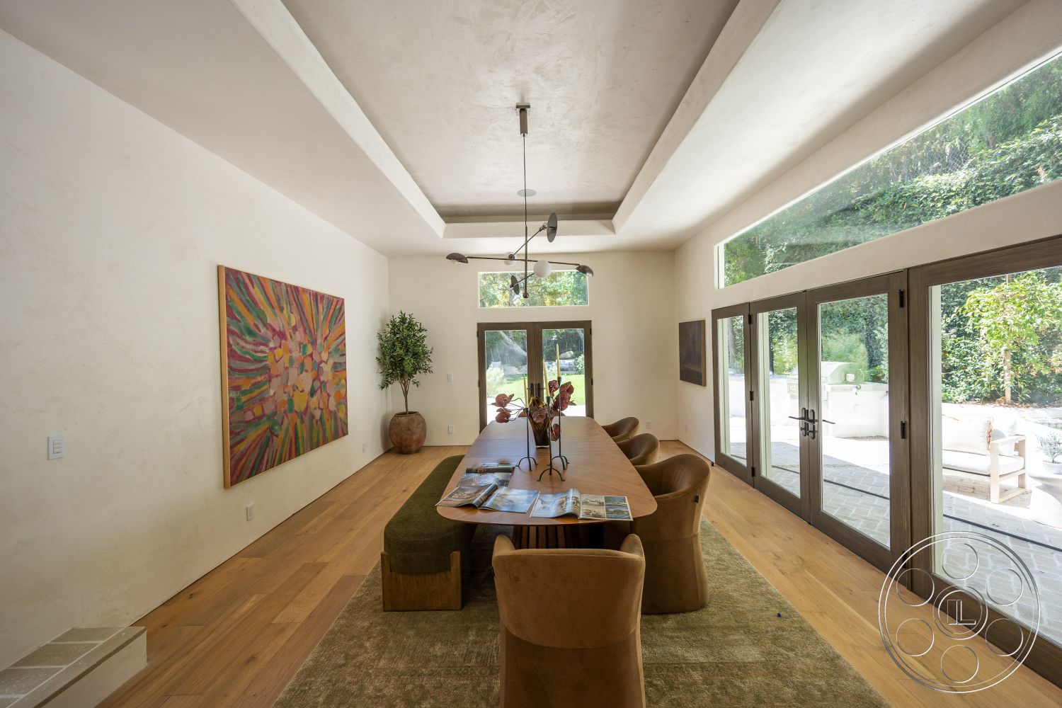 Medit 168 - area rug, exposed beam ceiling, large glass windows, decorative wall art, textured plaster walls, double French doors, modern dining chairs, contemporary dining table, indoor plant accents, light hardwood dining room floors