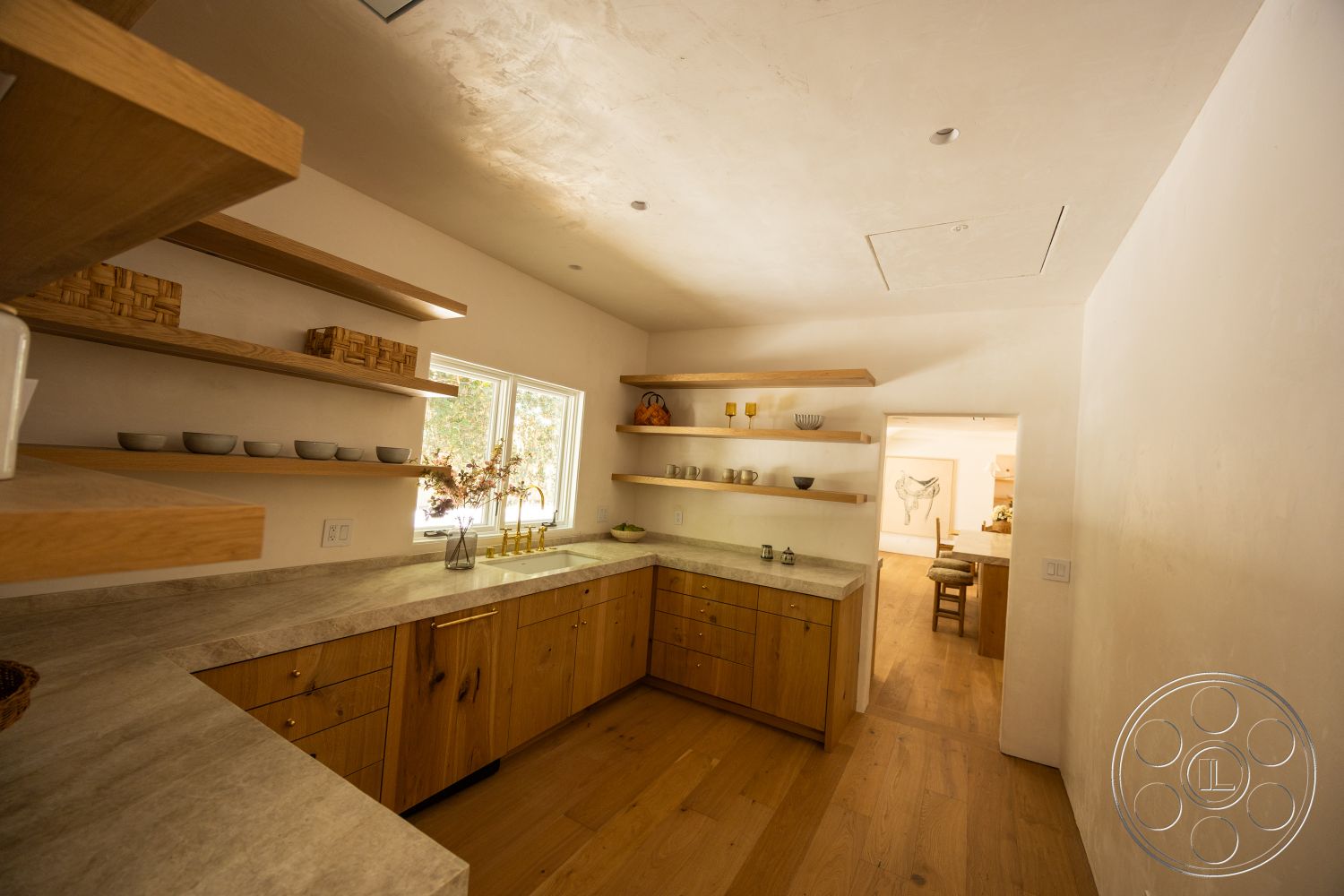 Medit 168 - minimalist decor, natural light, hardwood flooring, floor-to-ceiling windows, textured plaster walls, modern kitchen design, concrete kitchen countertops, wood kitchen cabinets, open shelving with wooden shelves