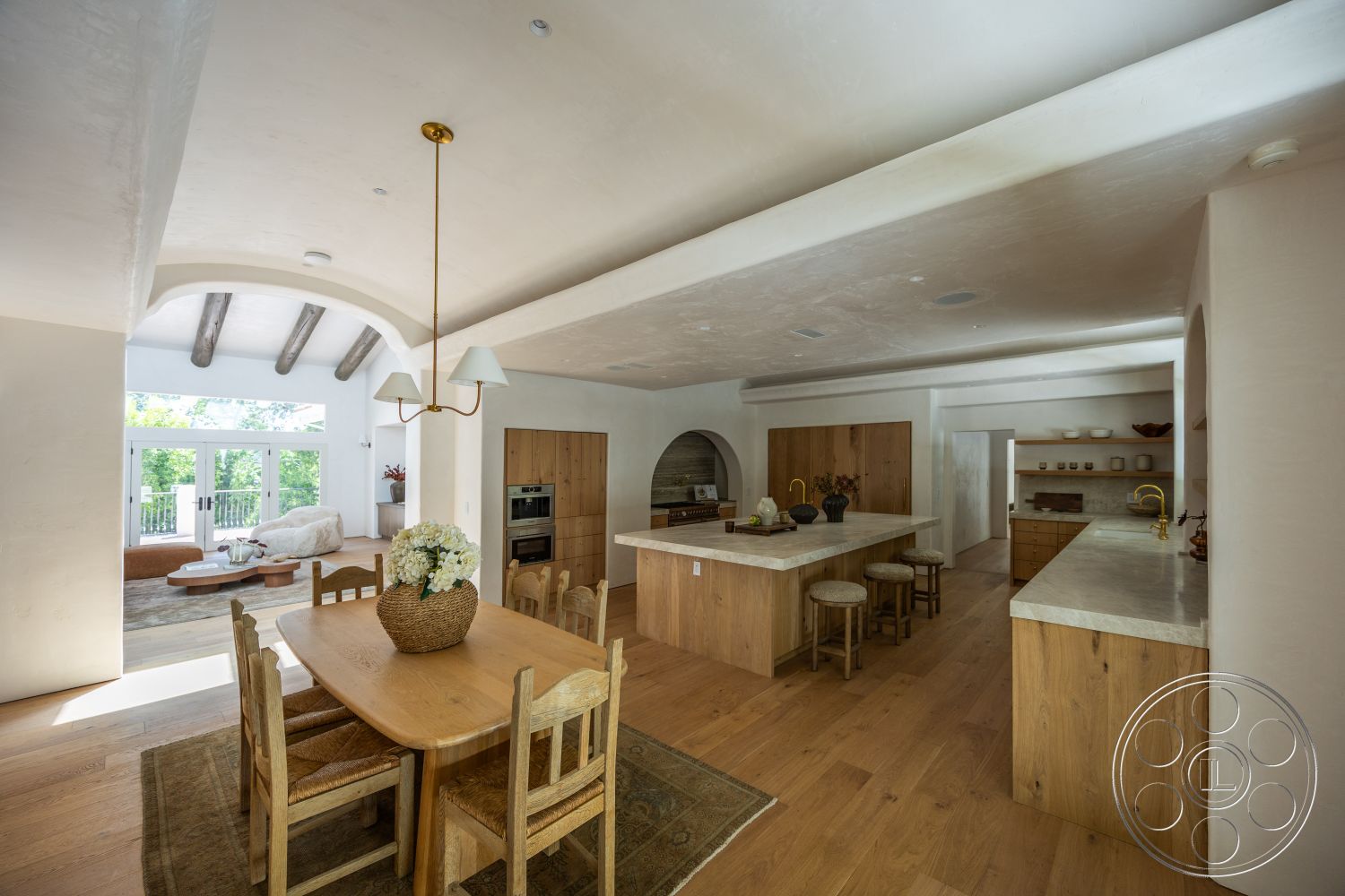 Medit 168 - neutral color palette, hardwood flooring, open floor plan, wood dining table, arched doorways, natural light from windows, wooden dining chairs, modern kitchen design, exposed wood ceiling beams, interior kitchen, stone kitchen countertops, built-in kitchen cabinets, plaster ceiling, counter-height seating