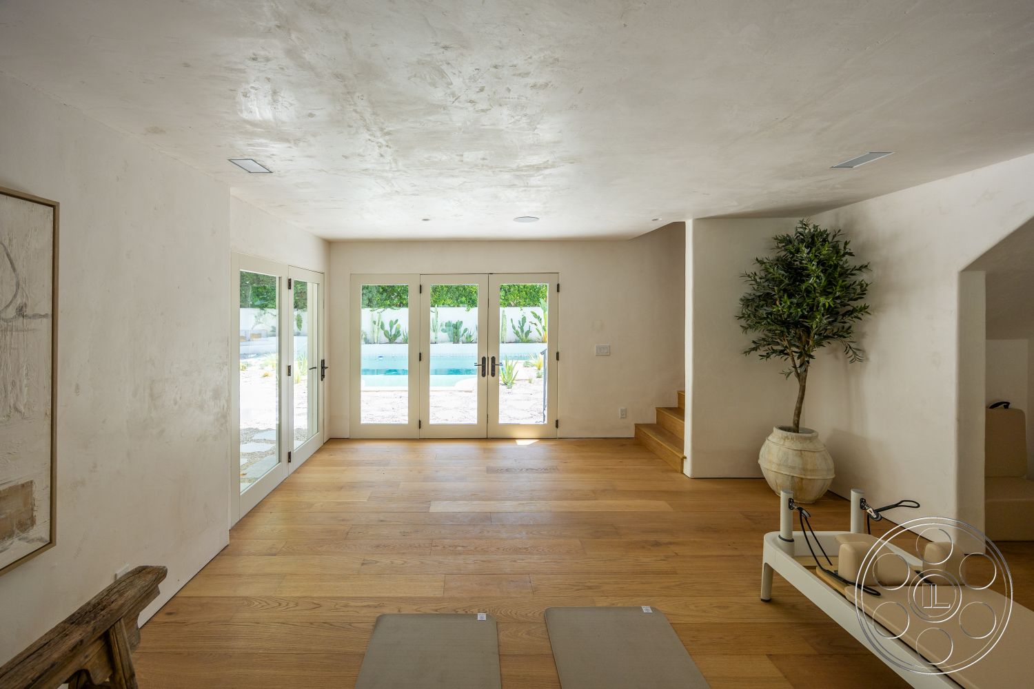 Medit 168 - natural light, hardwood flooring, minimalist design, open layout, concrete walls, floor-to-ceiling windows, exposed ceiling, stone planter, modern staircase, glass door entrance, light wood steps