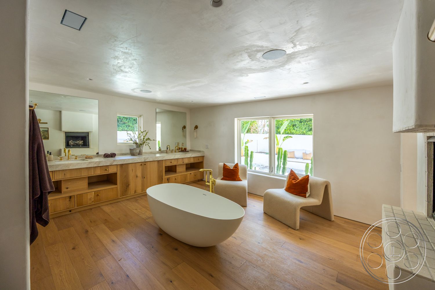 Medit 168 - neutral color palette, hardwood flooring, minimalist design, natural wood cabinetry, modern light fixtures, floor-to-ceiling windows, textured ceiling, white plaster walls, simplistic decor, freestanding soaking tub, marble bathroom vanity countertop, soft upholstered seating, yellow gold faucets, potted plants view