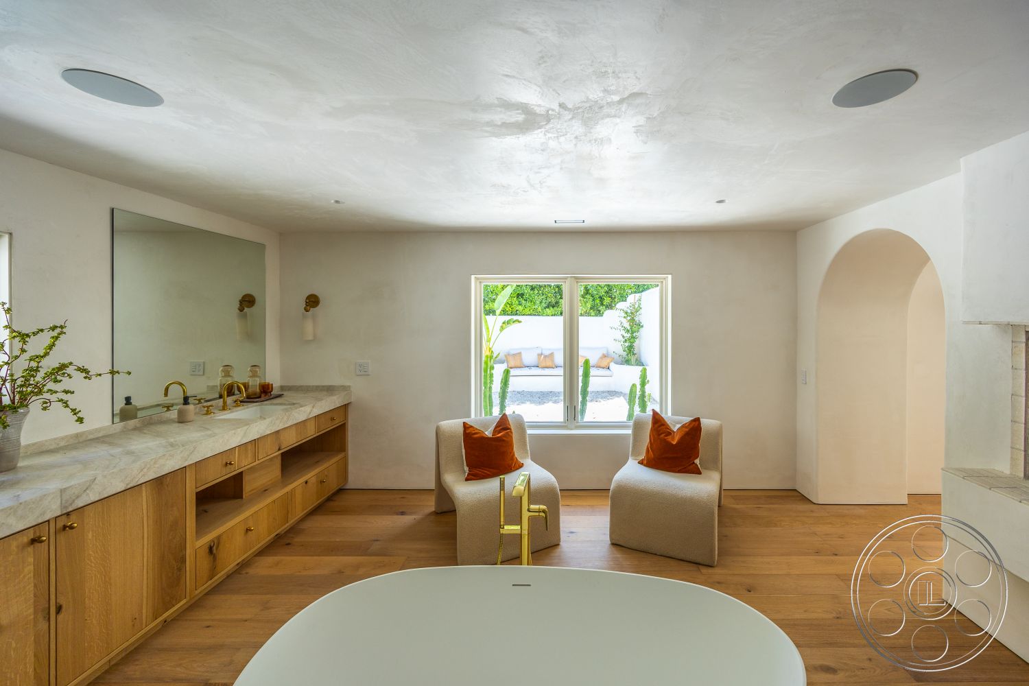 Medit 168 - light hardwood flooring, natural wood cabinetry, minimalist design elements, textured plaster ceiling, orange accent pillows, arched doorway, floor-to-ceiling window, plaster wall finish, modern lounge chairs, recessed lighting fixtures, marble vanity countertop