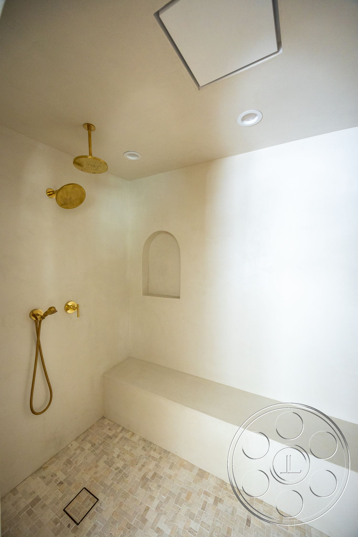 Medit 168 - recessed lighting, rain shower head, gold shower fixtures, minimalist shower design, built-in shower bench, textured plaster shower walls, mosaic tile shower flooring, handheld shower wand