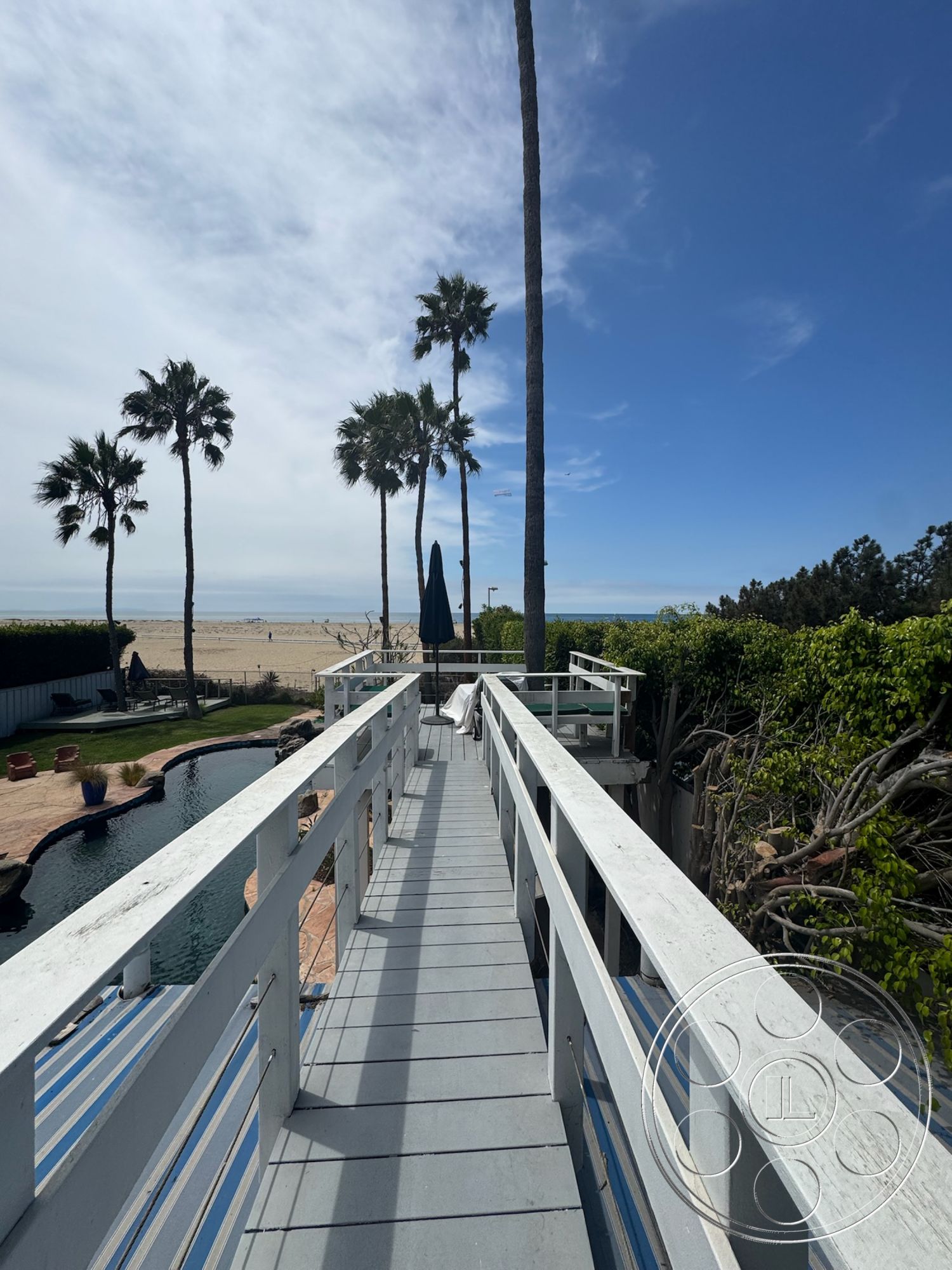 Lloyd Beach House - exterior, landscaped garden, blue sky, wooden walkway, tropical palm trees, outdoor living area, poolside area, paved patio flooring, beachfront setting, open beach view