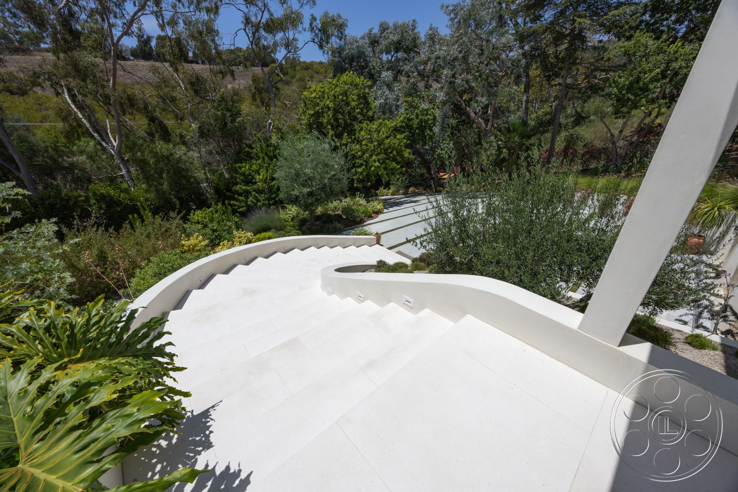 Americana 434 - exterior, tropical plants, concrete pathway, scenic hillside view, aloe vera plants, surrounding landscaped garden, variety of shrubs, dense greenery, white concrete curved staircase, low-maintenance groundcover