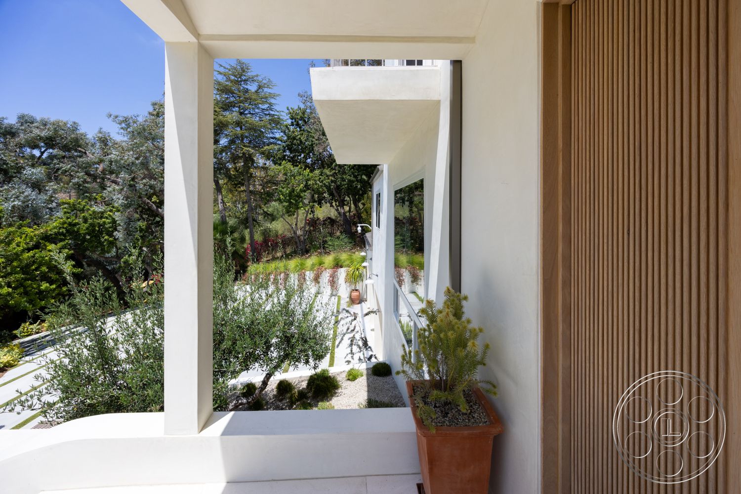Americana 434 - natural light, exterior, potted plants, textured wall finish, floor-to-ceiling windows, modern architectural style, minimalist landscaping, stone planter, green garden, large overhang roof, curved garden pathway, concrete porch, wooden slat wall, outdoor natural setting