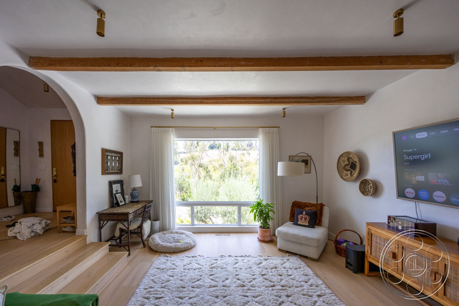 Americana 434 - neutral color palette, hardwood flooring, modern lighting fixtures, decorative wall art, large floor-to-ceiling windows, wooden accent furniture, exposed wood ceiling beams, interior living room, white textured plaster walls, curved archway