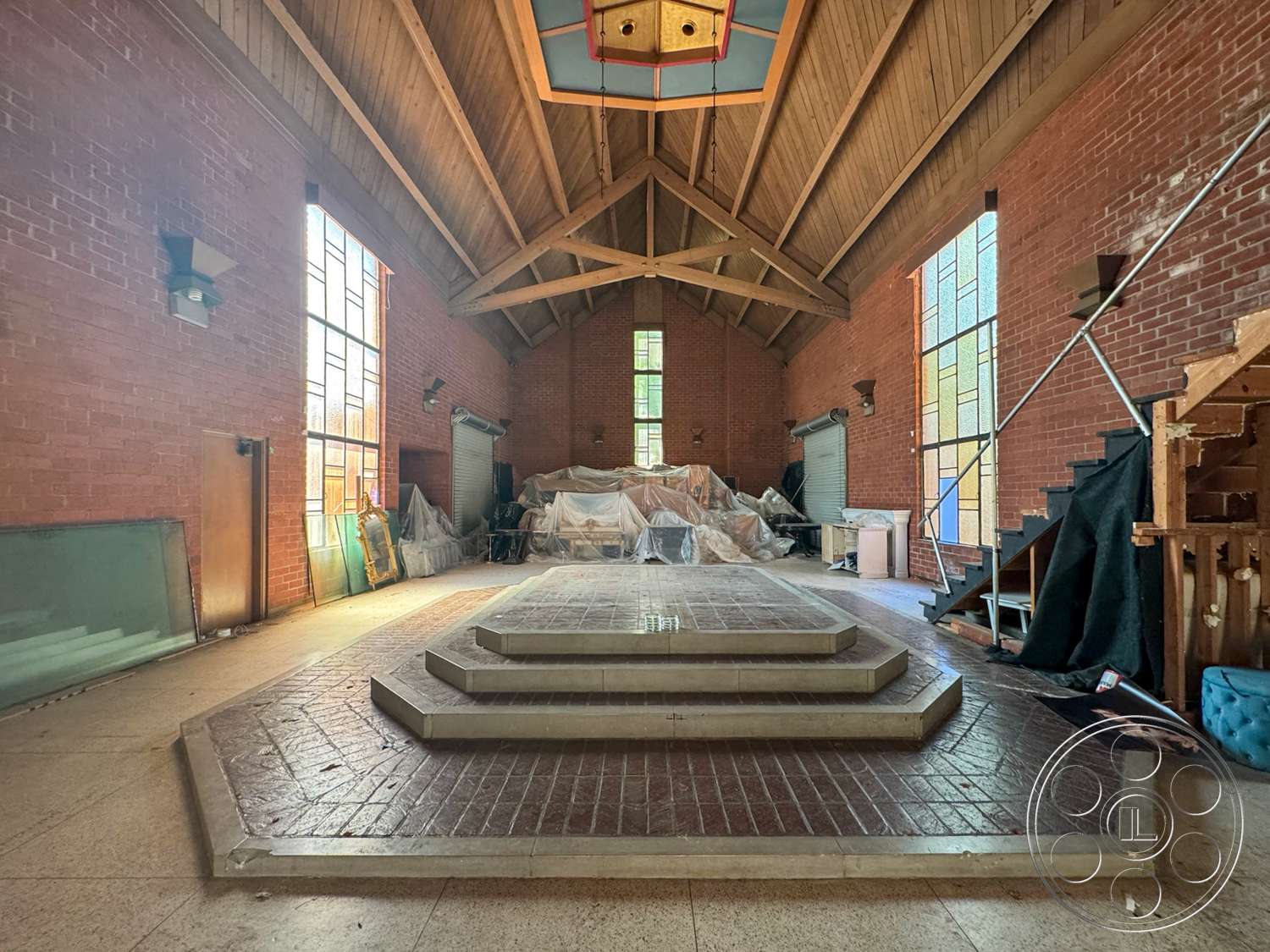 The Rosenheim Mansion - large windows, exterior, brick walls, industrial lighting fixtures, brick flooring, concrete steps, vaulted ceiling, stained glass windows, wood beam ceiling, open interior space, stacked stone feature wall, built-in wooden steps
