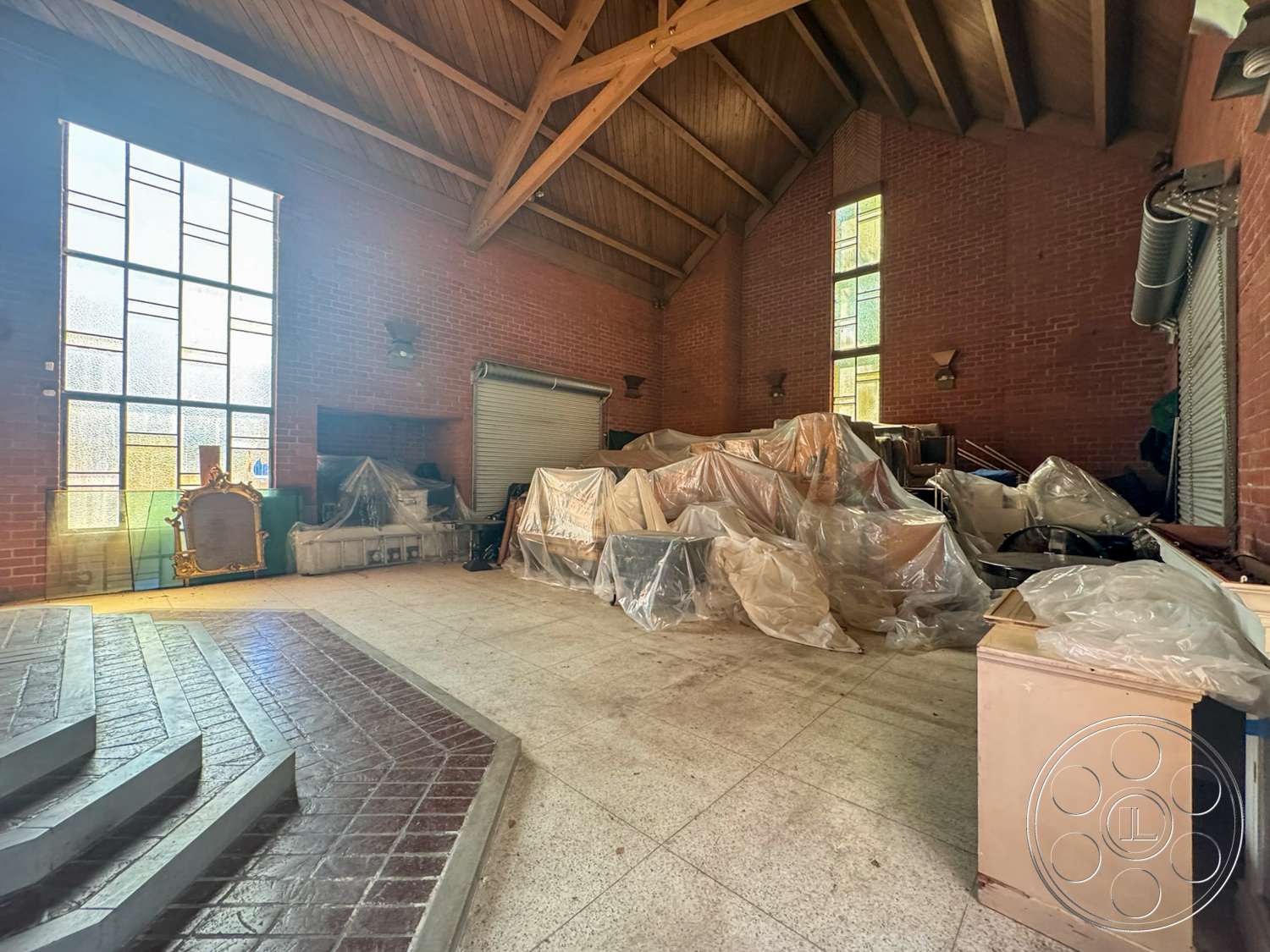 The Rosenheim Mansion - open space layout, brick walls, concrete steps, high vaulted ceiling, stained glass windows, exposed wood ceiling beams, rectangular tile flooring