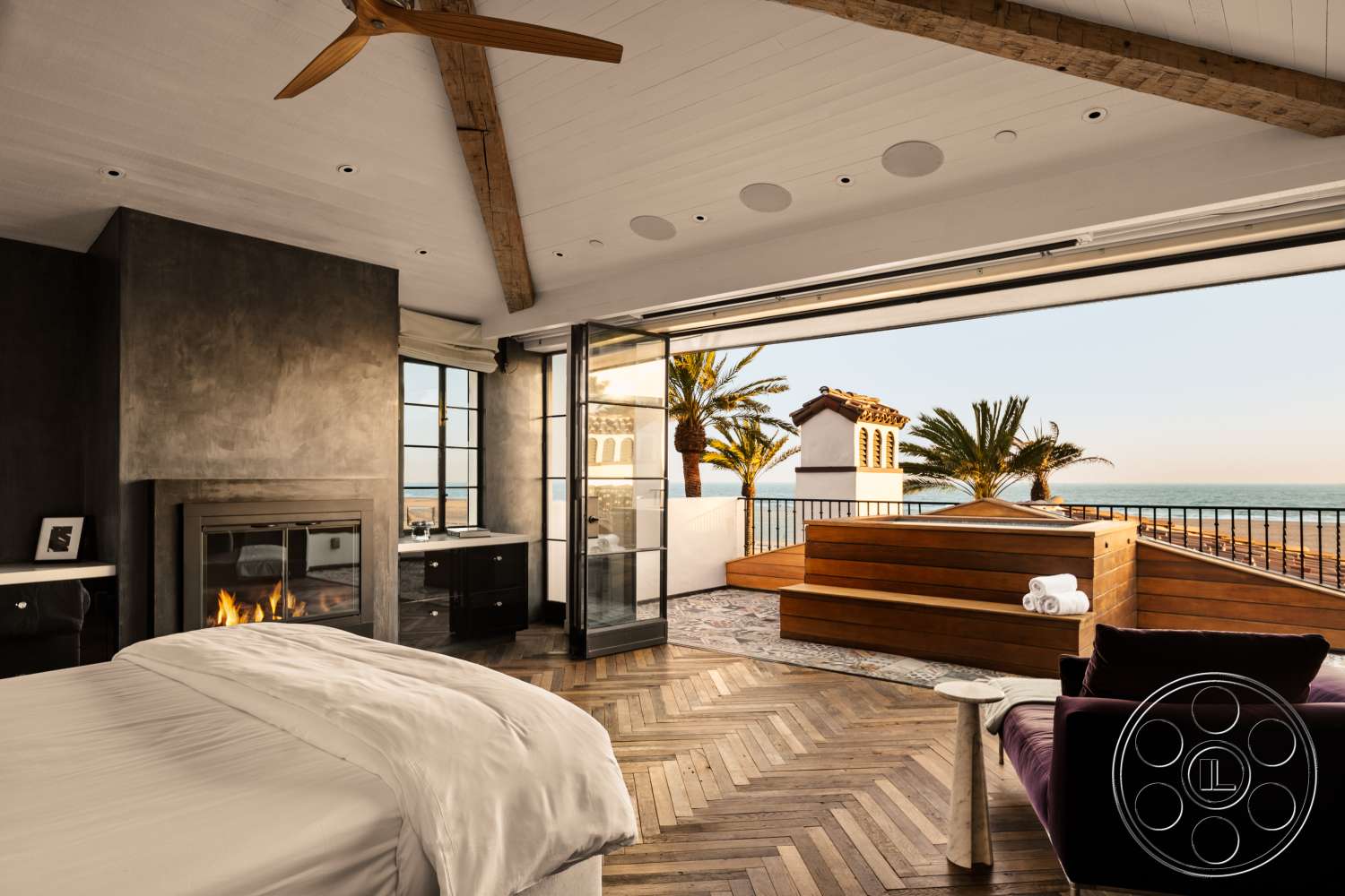 Beach 137 - contemporary furnishings, panoramic ocean view, wood beam ceiling, modern fireplace surround, open layout design, palm tree landscaping, dark textured plaster walls, chevron hardwood bedroom floors, glass door opening to outdoor area, minimalist built-in furniture, outdoor wooden deck