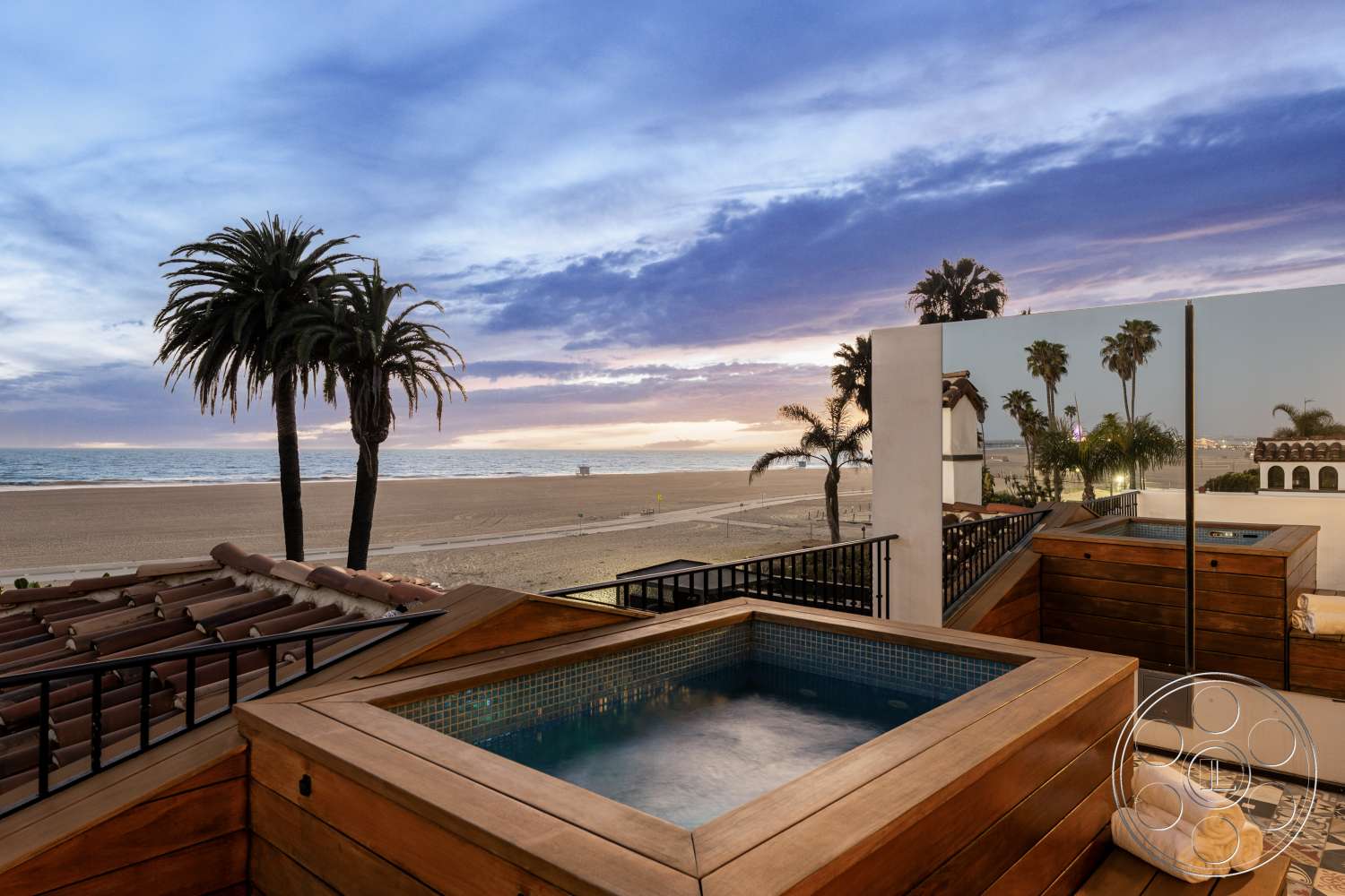 Beach 137 - exterior, palm trees, contemporary architecture, terracotta tile roof, sunset sky, beachfront view, modern outdoor spa, modern outdoor living space, wooden hot tub deck, glass tiles in hot tub, open patio railing