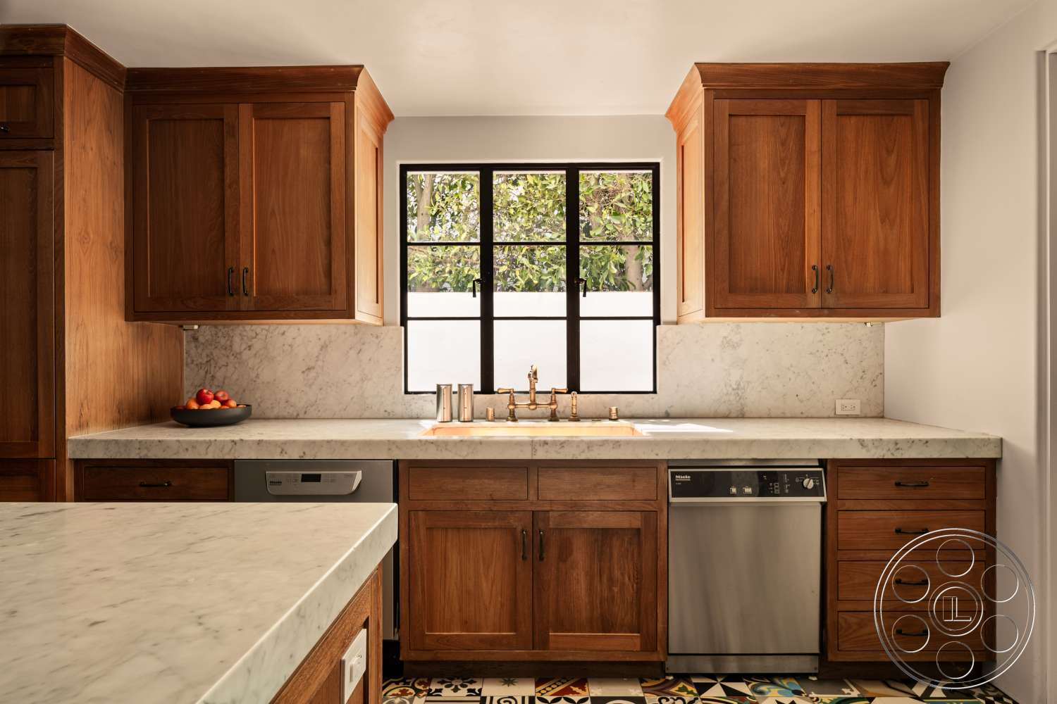 Beach 137 - wood cabinetry, marble countertop, textured plaster walls, under-cabinet lighting, stainless steel dishwasher, tile kitchen backsplash, copper kitchen faucet, black window frame, colorful patterned tile flooring