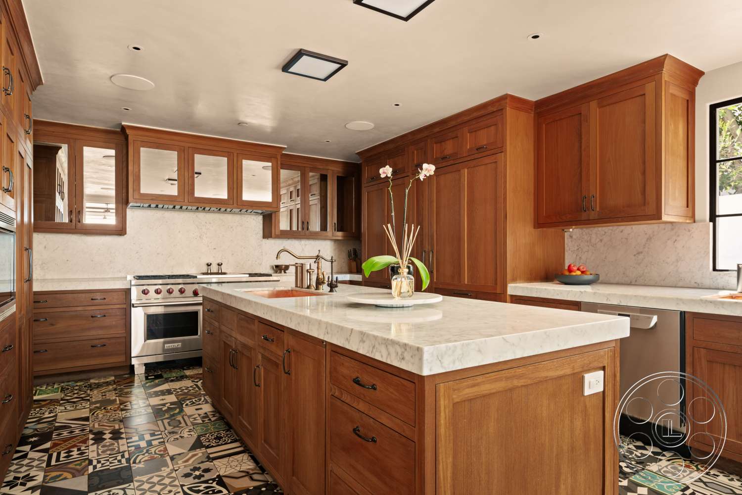 Beach 137 - stainless steel appliances, marble countertop, textured plaster walls, under-cabinet lighting, kitchen island with seating, walnut kitchen cabinets, decorative patterned tile flooring, glass windows allowing natural light, built-in kitchen cabinet storage