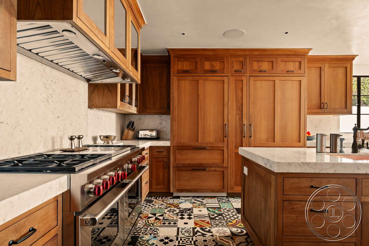 Beach 137 - wood cabinetry, black hardware, open shelving, marble kitchen countertops, stainless steel gas range, colorful patterned tile flooring, exposed range hood, honed marble wall backsplash, traditional kitchen design