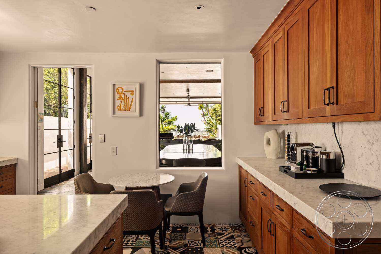 Beach 137 - dark wood cabinetry, minimalist decor, natural light, open layout, upholstered dining chairs, floor-to-ceiling windows, round dining table, outdoor view, textured tile flooring, white plaster walls, marble kitchen countertop, glass door entry, black tile backsplash