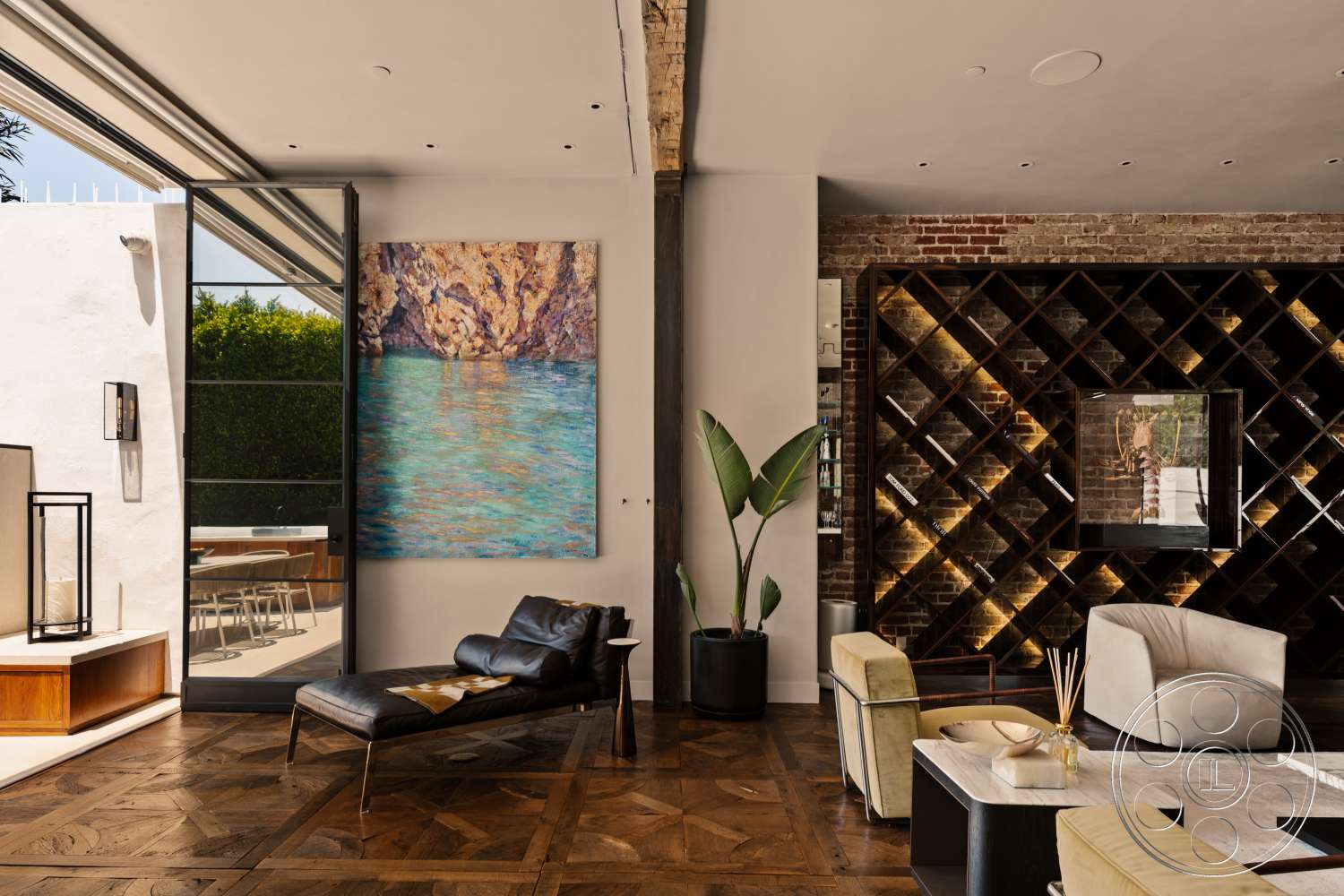Beach 137 - neutral color palette, open floor plan, bright natural light, abstract wall art, sliding glass doors, floor-to-ceiling windows, contemporary design elements, dark wood paneling, minimalist coffee table, modern lounge chair, exposed brick accent wall, parquet wood flooring, wooden wine rack with LED lighting, plants as interior decor