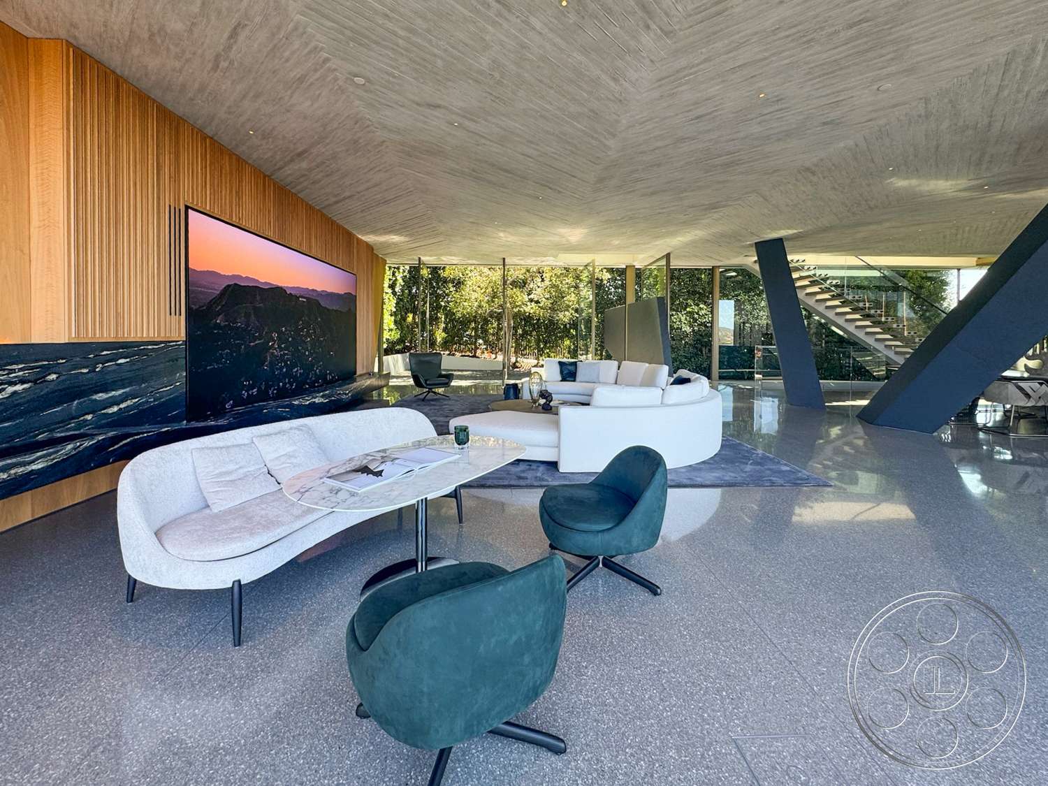 Modern 516 - minimalist decor, round coffee table, textured area rug, open floor plan, polished concrete flooring, modern lighting fixtures, glass sliding doors, floor-to-ceiling windows, exposed concrete ceiling, contemporary living room, wood panel accent wall, curved modern sofa, indoor greenery view, dark stone feature wall, angular steel staircase