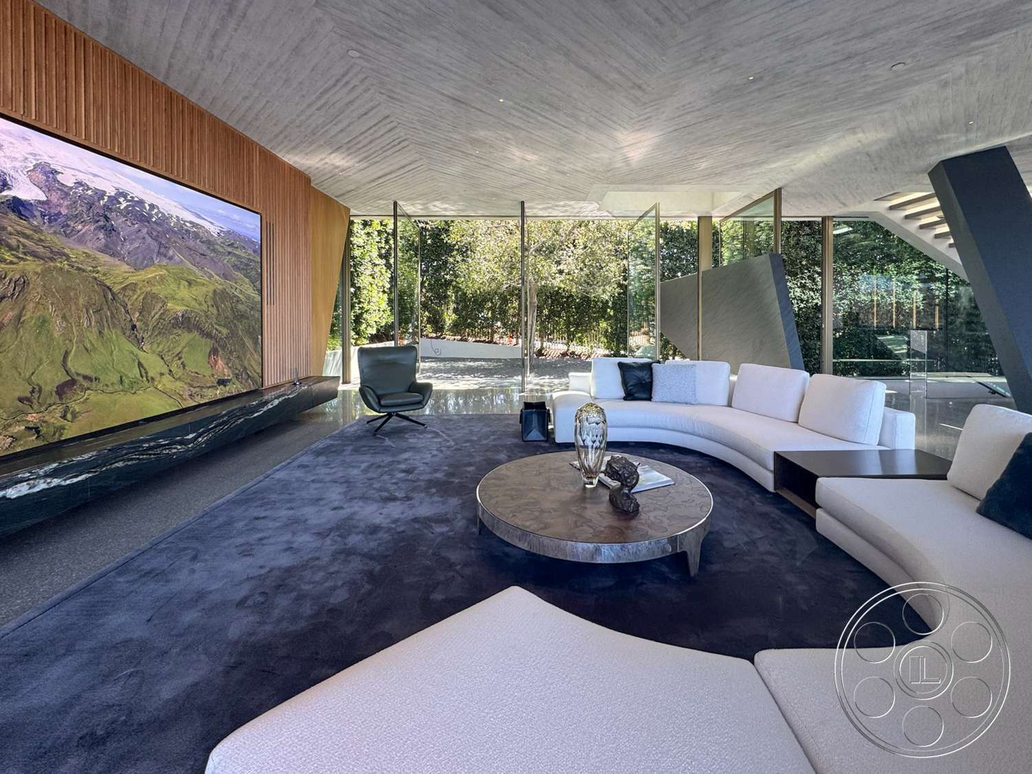 Modern 516 - minimalist decor, open floor plan, nature view, glass walls, floor-to-ceiling windows, marble coffee table, wood accent wall, concrete ceiling, curved sofa, modern lounge chair, plush carpet flooring, dark stone base