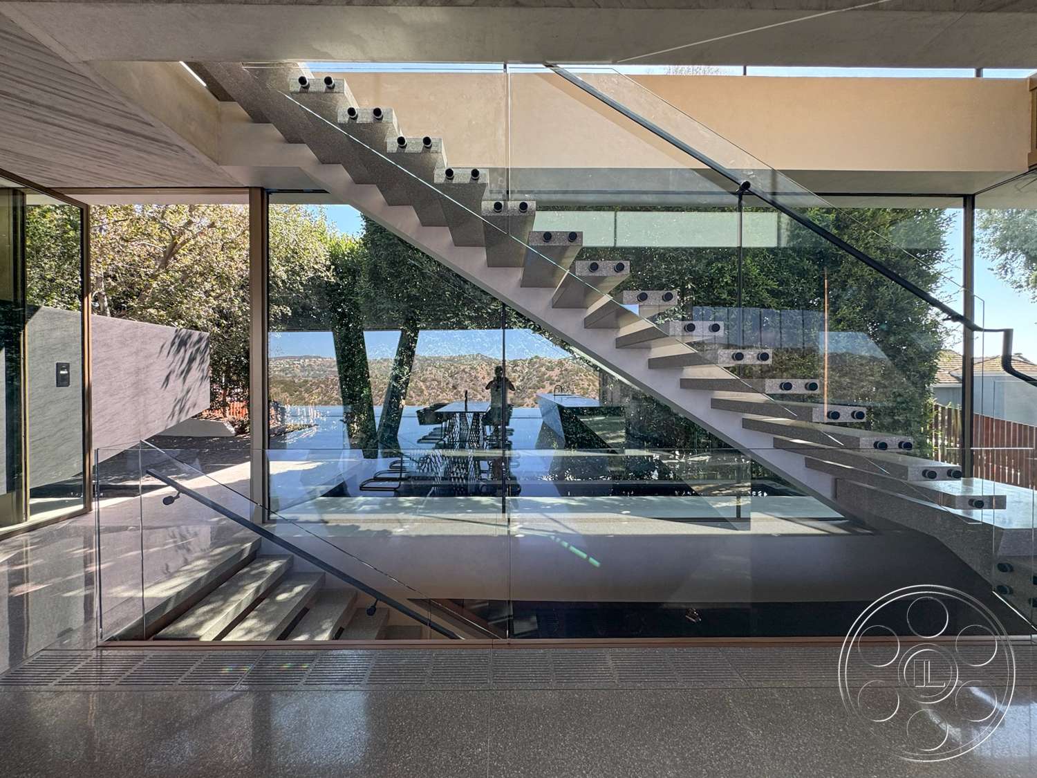 Modern 516 - exterior, polished concrete flooring, landscape view, concrete walls, floor-to-ceiling windows, vaulted ceiling, modern architectural style, floating stairs, glass stair railings