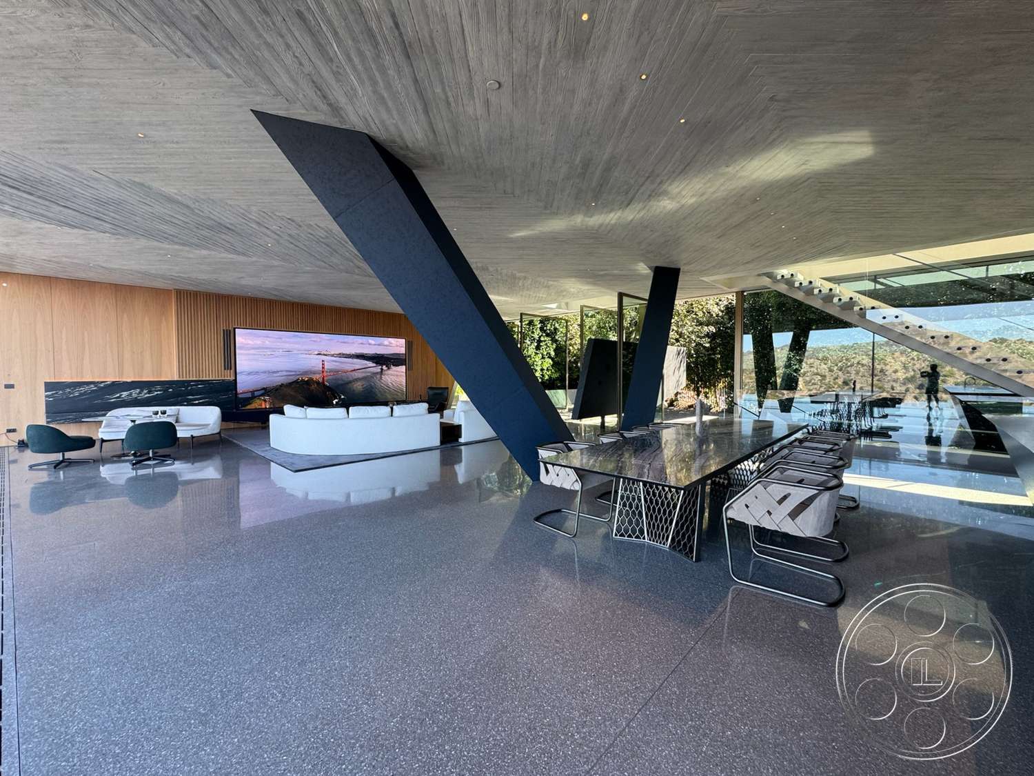 Modern 516 - minimalist design, open floor plan, floor-to-ceiling windows, luxury living room, exposed concrete ceiling, terrazzo floor, glass wall, flat screen television, contemporary interior, modern sofa, oval dining table, wood panel accent wall, black steel structural supports