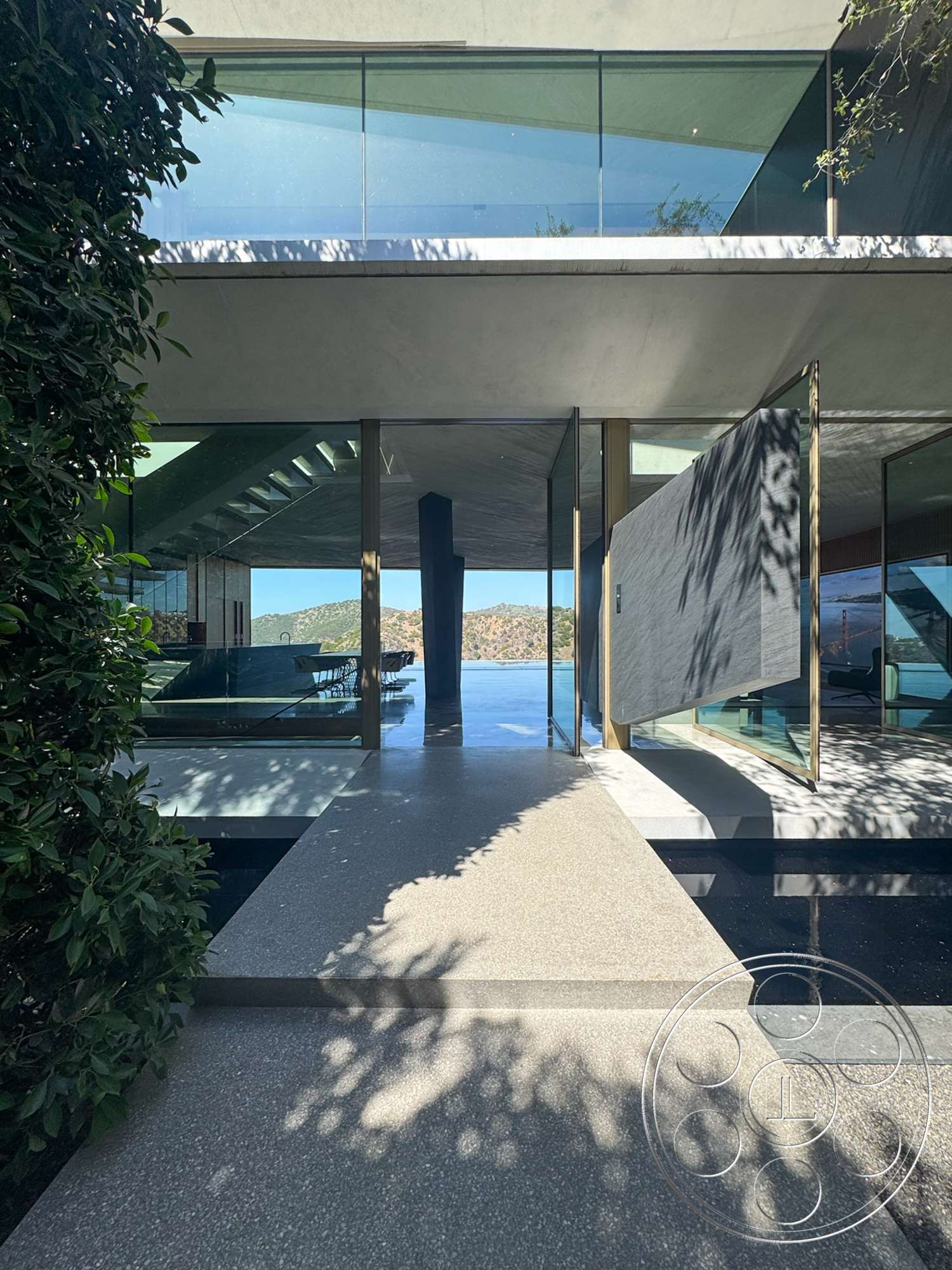 Modern 516 - exterior, open floor plan, surrounding greenery, floor-to-ceiling windows, multilevel structure, glass facade, modern architectural style, mountain view, steel frames, flat roof design, natural light streaming, polished concrete walkway, cantilevered elements, elevated outdoor deck