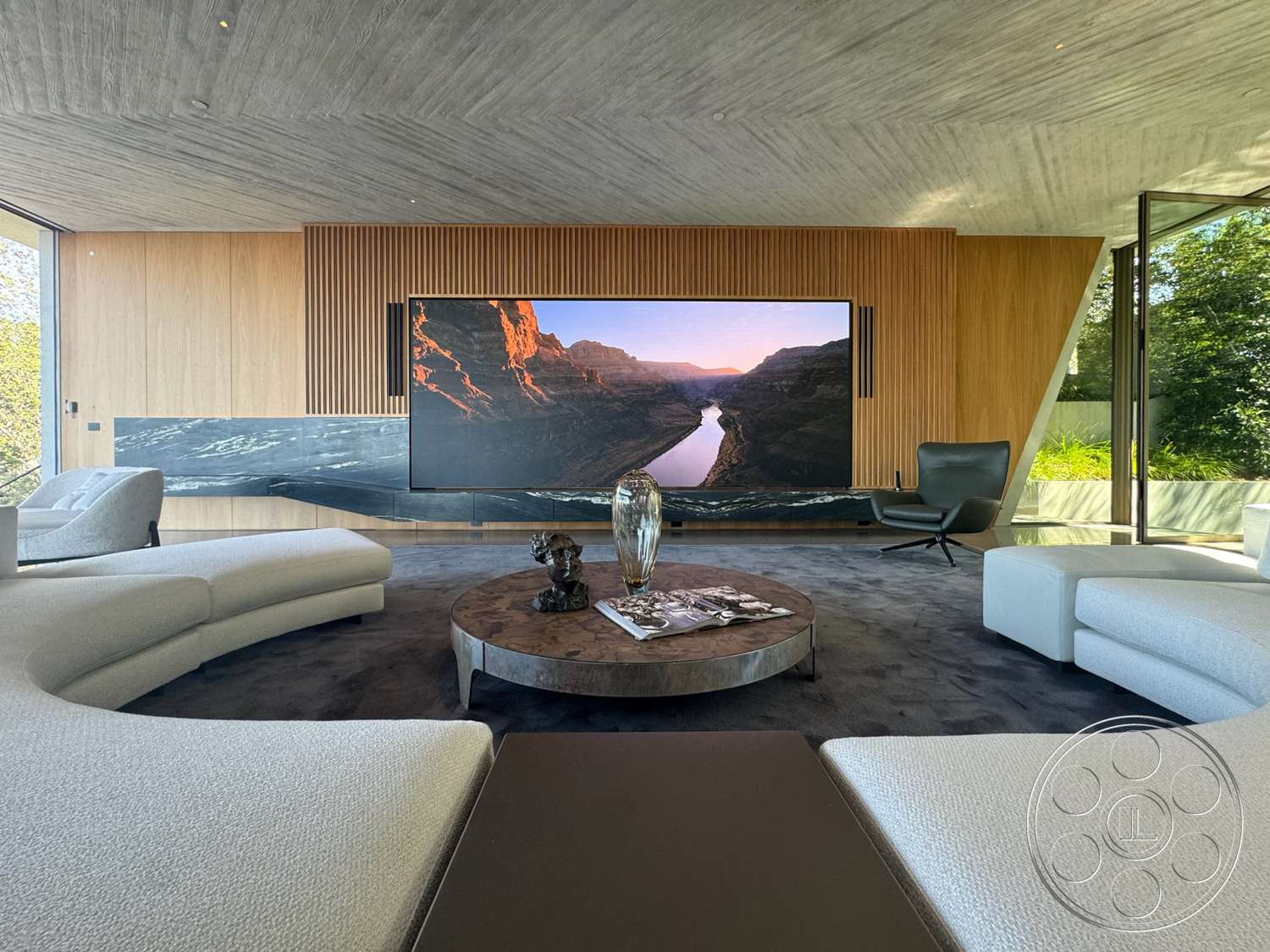 Modern 516 - natural light, minimalist design, round coffee table, open floor plan, floor-to-ceiling windows, luxurious living room, exposed concrete ceiling, plush area rug, large flat-screen TV, modern armchair, curved sectional sofa, contemporary interior, black marble feature wall, wood panel accent wall