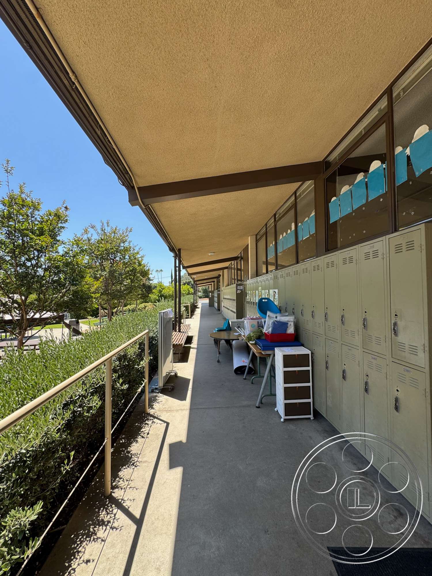 School 20 - exterior, benches, metal railings, glass windows, concrete walkway, pedestrian pathway, metal lockers, landscaped shrubs, sunlit corridor, exposed ceiling with acoustic panels, outdoor educational setting