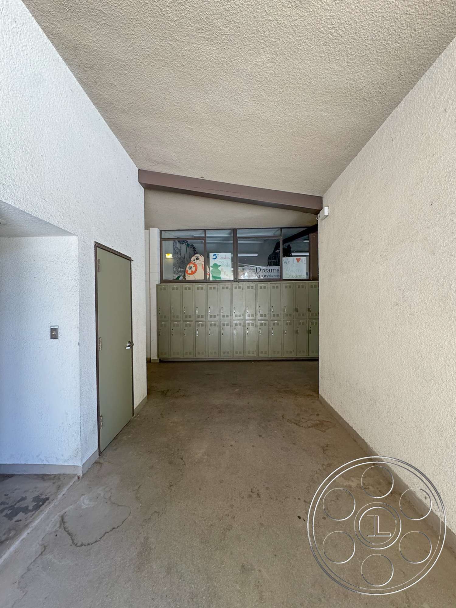 School 20 - exterior, modern architecture, minimalist design, concrete floor, vaulted ceiling, textured plaster walls, horizontal window alignment, slate gray door, bronze metal window frames, locker storage area