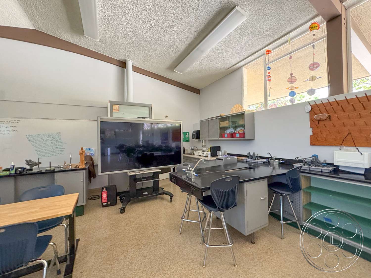 School 20 - exposed wooden beams, metal bar stools, glass cabinet doors, green cabinetry, LED lighting fixtures, textured ceiling tiles, whiteboard wall, interior classroom, laminate classroom tables, engineered wood trim, black countertop workstations, window wall with decorative elements