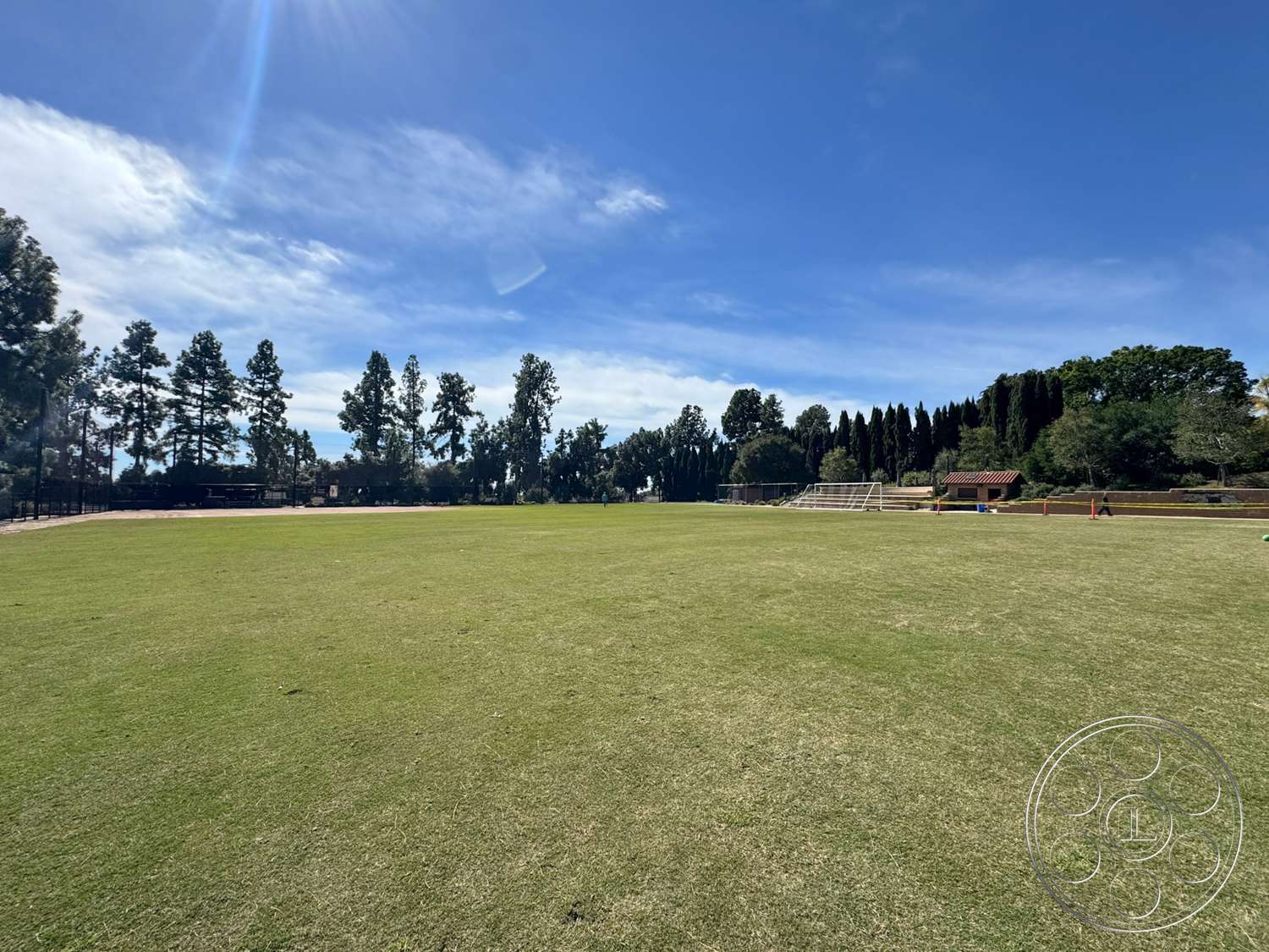 School 20 - exterior, seating area, surrounding trees, natural landscape, clear blue sky, sports field, park setting, well-maintained grass, open green field