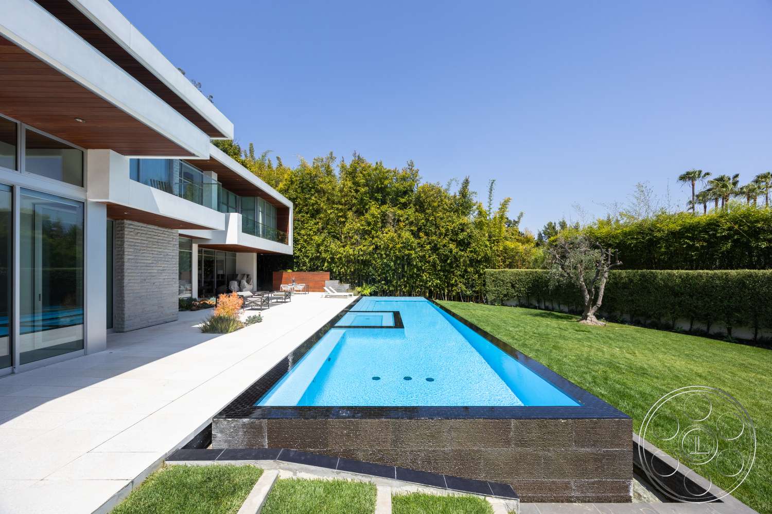 Modern 14 - exterior, floor-to-ceiling windows, landscaped backyard, modern architectural style, infinity pool, wood ceiling beams, glass patio doors, stone feature wall, planted garden beds, concrete pool border, rectangular patio, turf lawn, grey stone cladding, light concrete patio flooring
