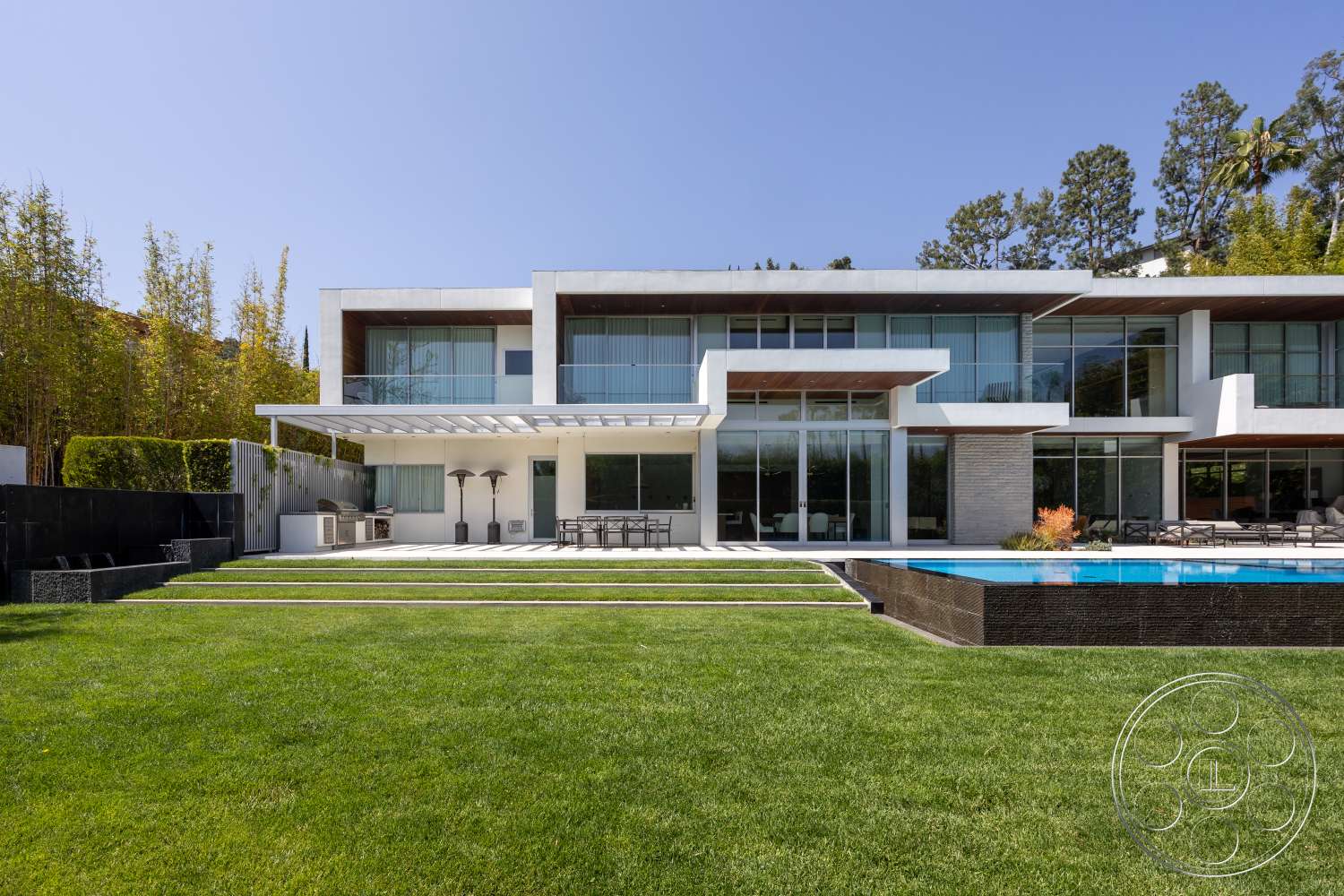 Modern 14 - exterior, landscaped garden, flat roof, wood paneling, glass sliding doors, floor-to-ceiling windows, stone pathway, horizontal wood fencing, modern architectural style, concrete pool deck, rectangular pool, metal pergola, open patio area, lawn with grass